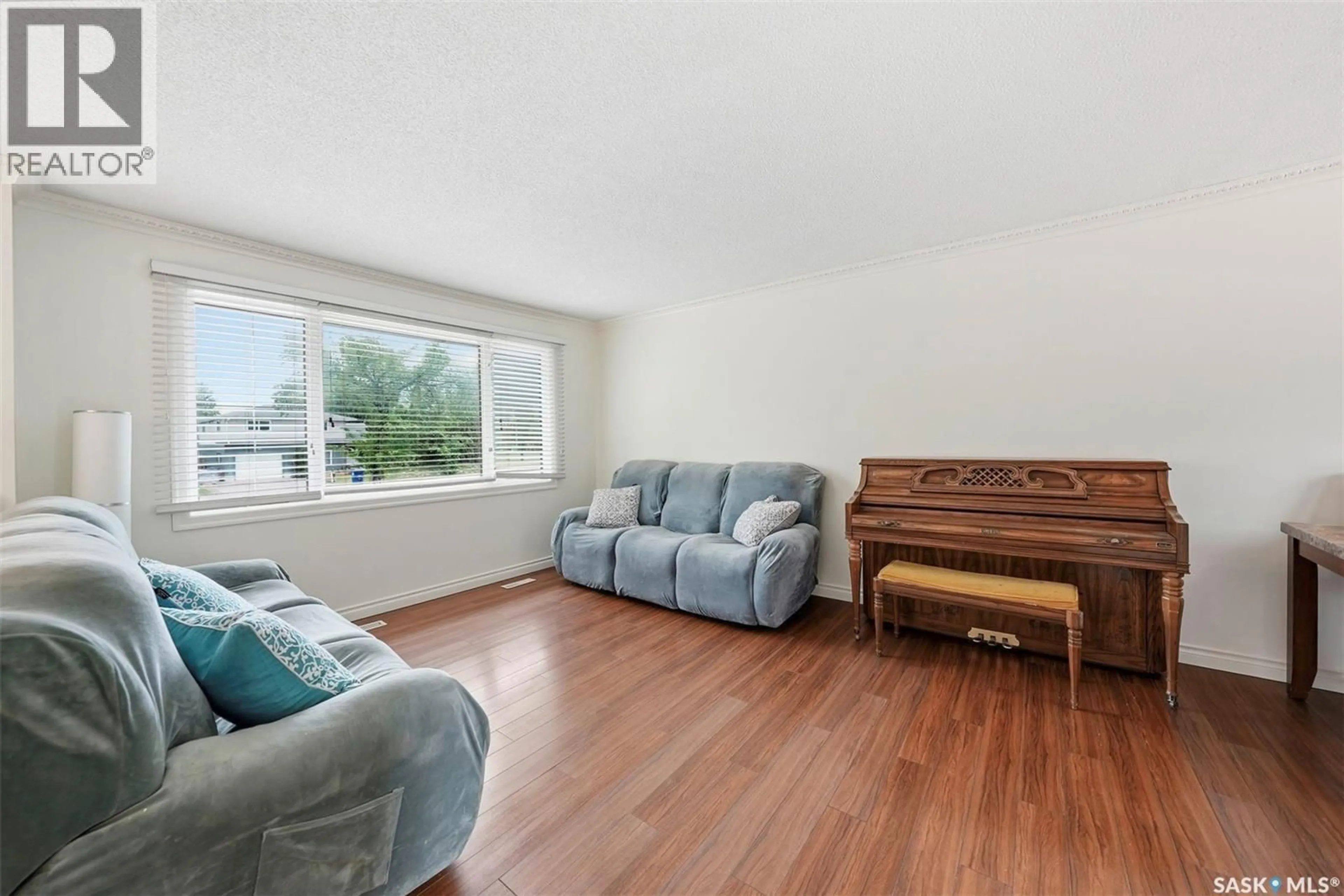 Living room with furniture, wood/laminate floor for 526 MCKERCHER DRIVE, Saskatoon Saskatchewan S7H3W6