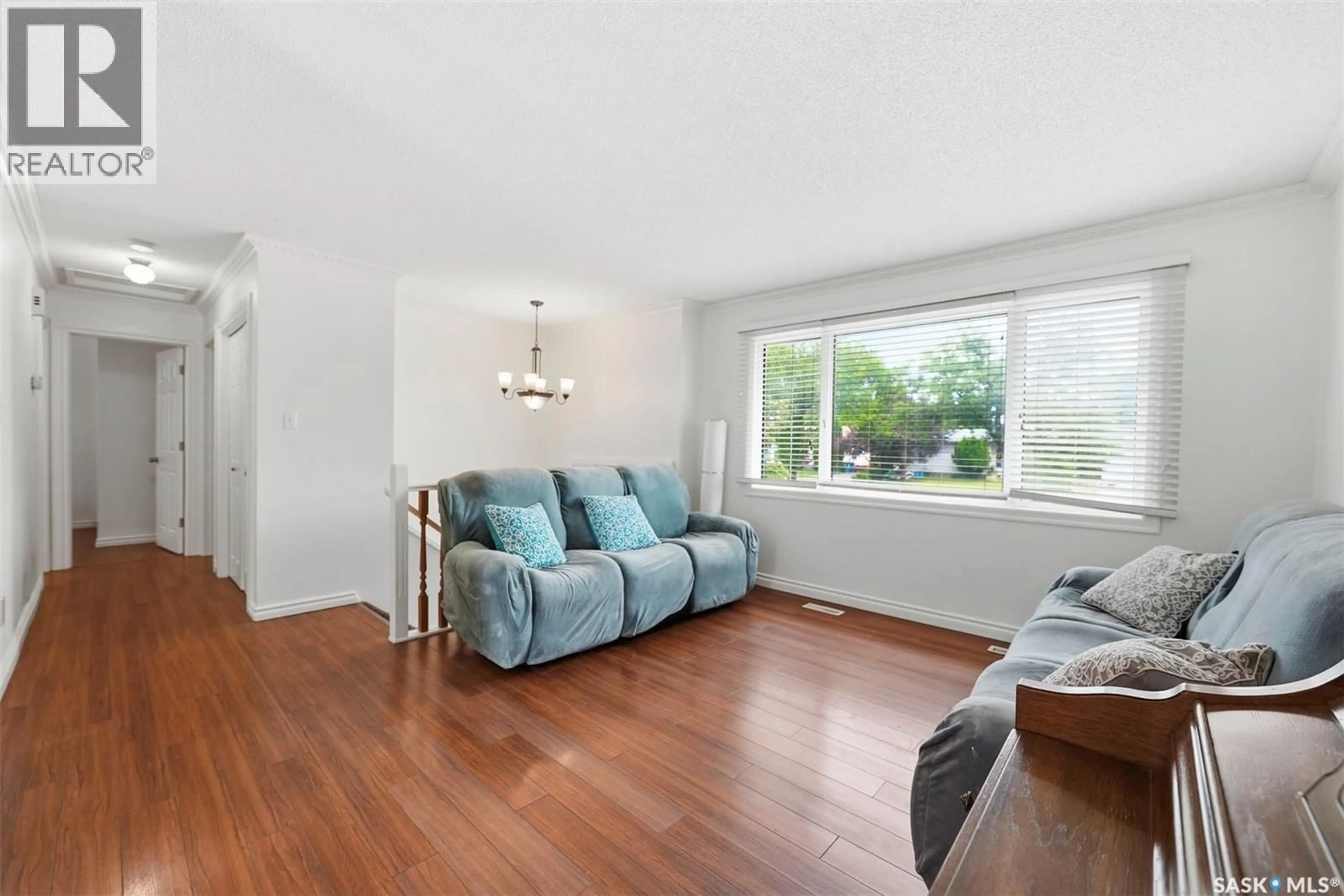 Living room with furniture, wood/laminate floor for 526 MCKERCHER DRIVE, Saskatoon Saskatchewan S7H3W6