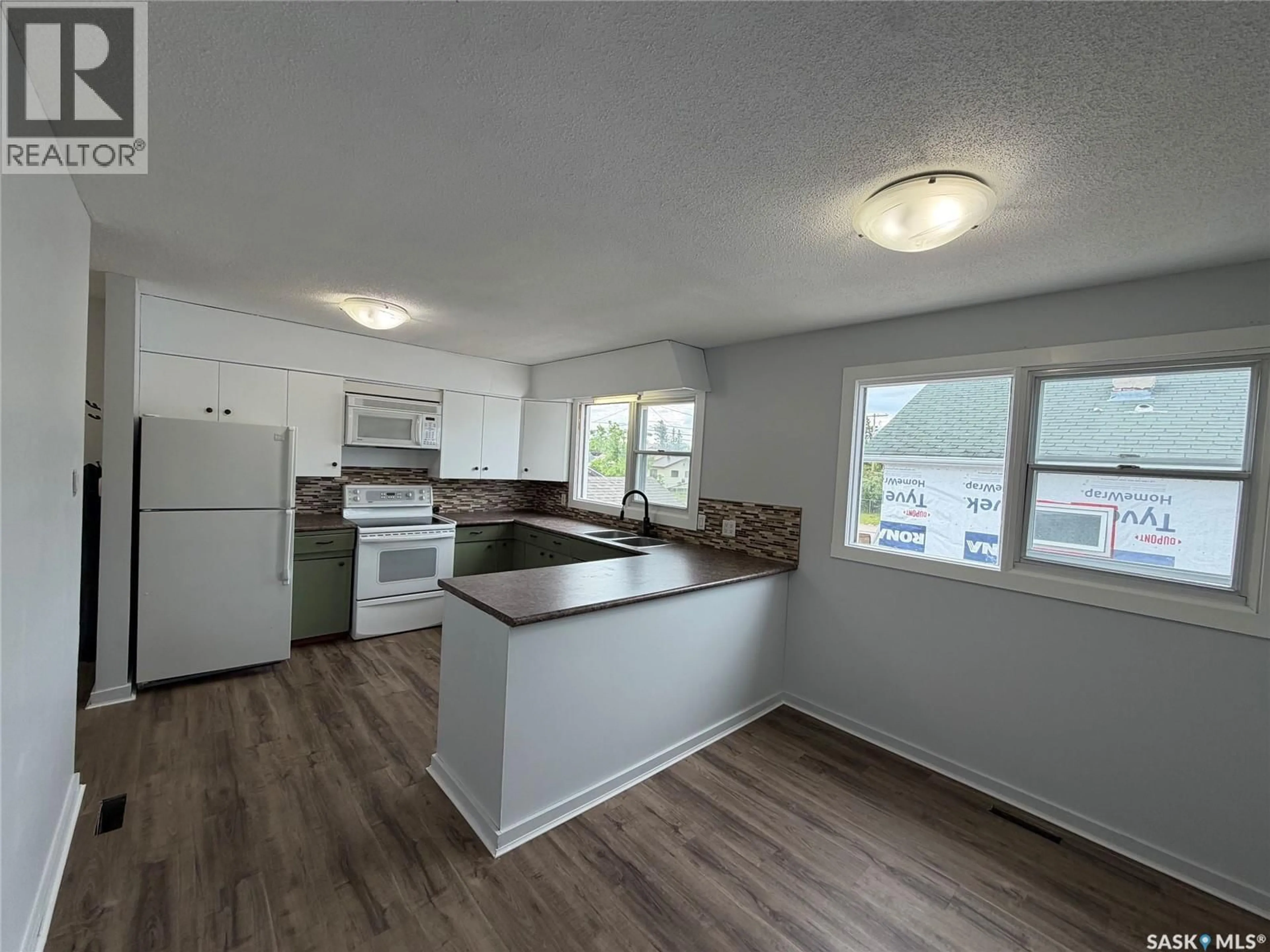 Open concept kitchen, wood/laminate floor for 118 HUDSON STREET, Hudson Bay Saskatchewan S0E0Y0