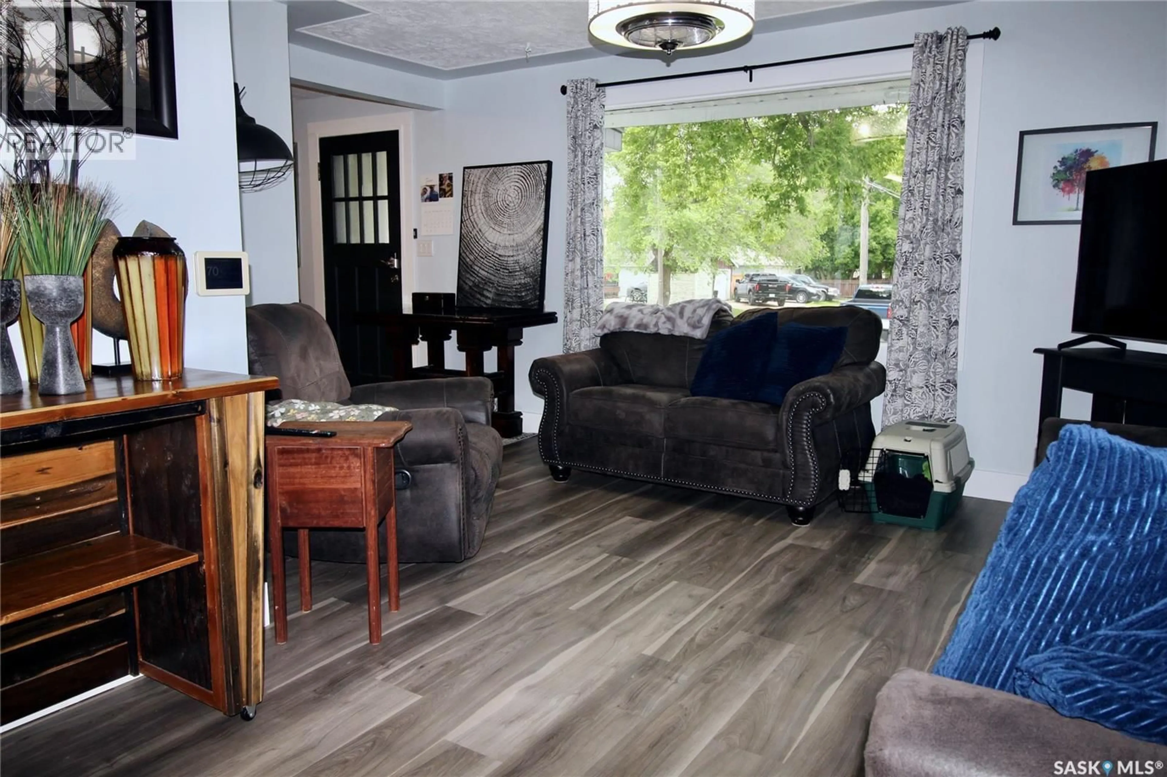Living room with furniture, wood/laminate floor for 808 ELLICE STREET, Moosomin Saskatchewan S0G3N0