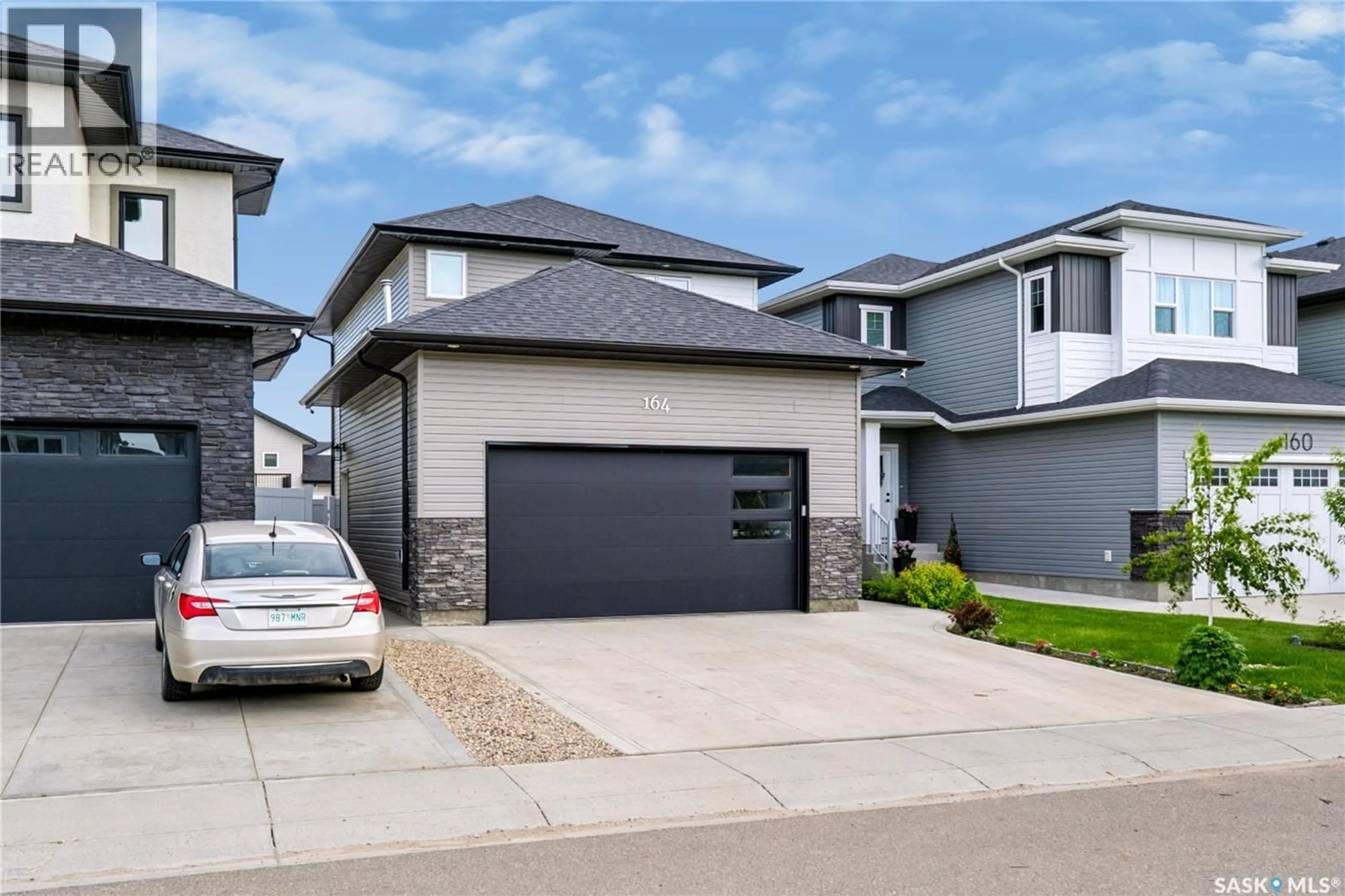 Home with vinyl exterior material, street for 164 THAKUR STREET, Saskatoon Saskatchewan S7W1C4