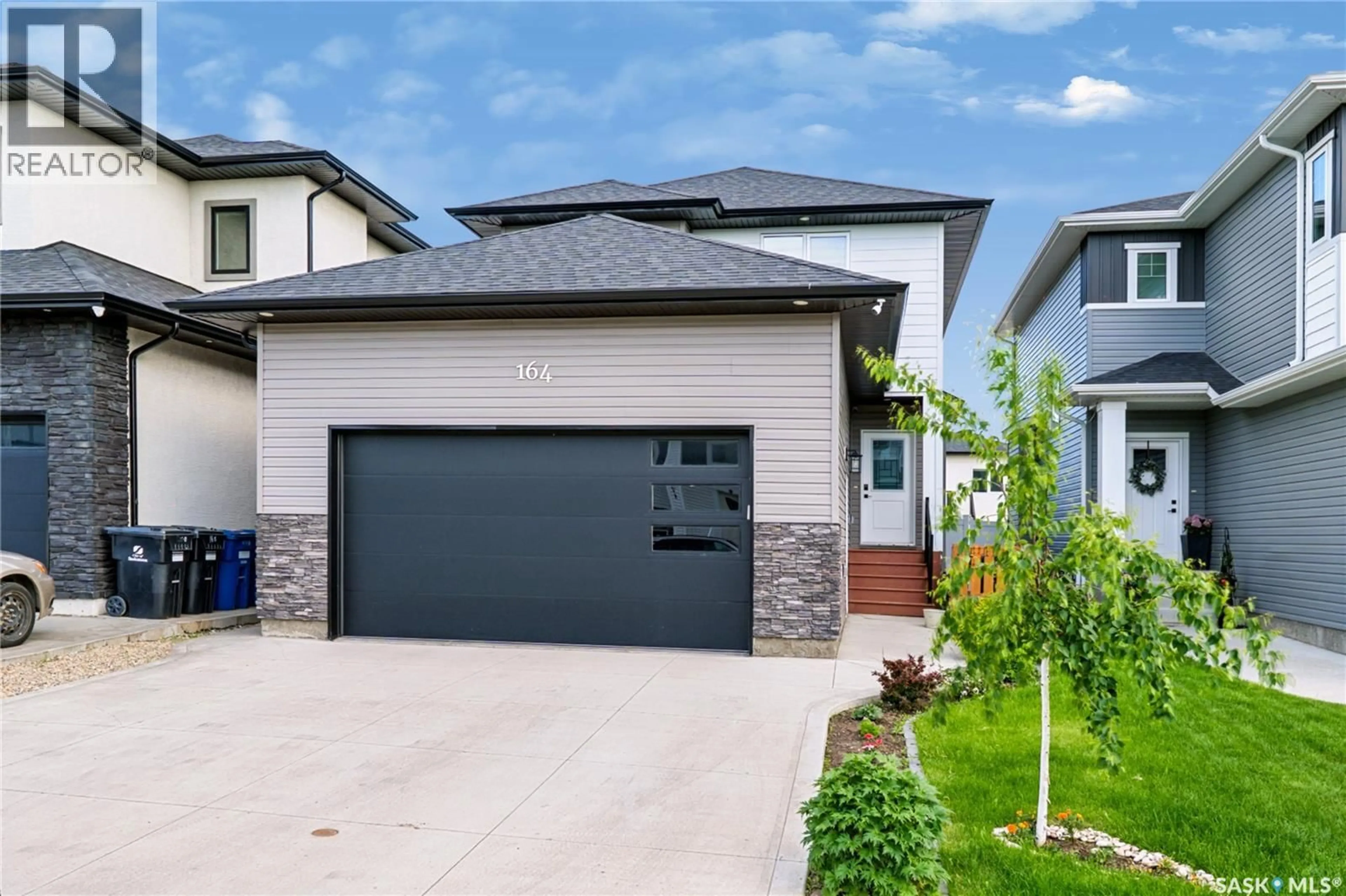 Home with vinyl exterior material, street for 164 THAKUR STREET, Saskatoon Saskatchewan S7W1C4
