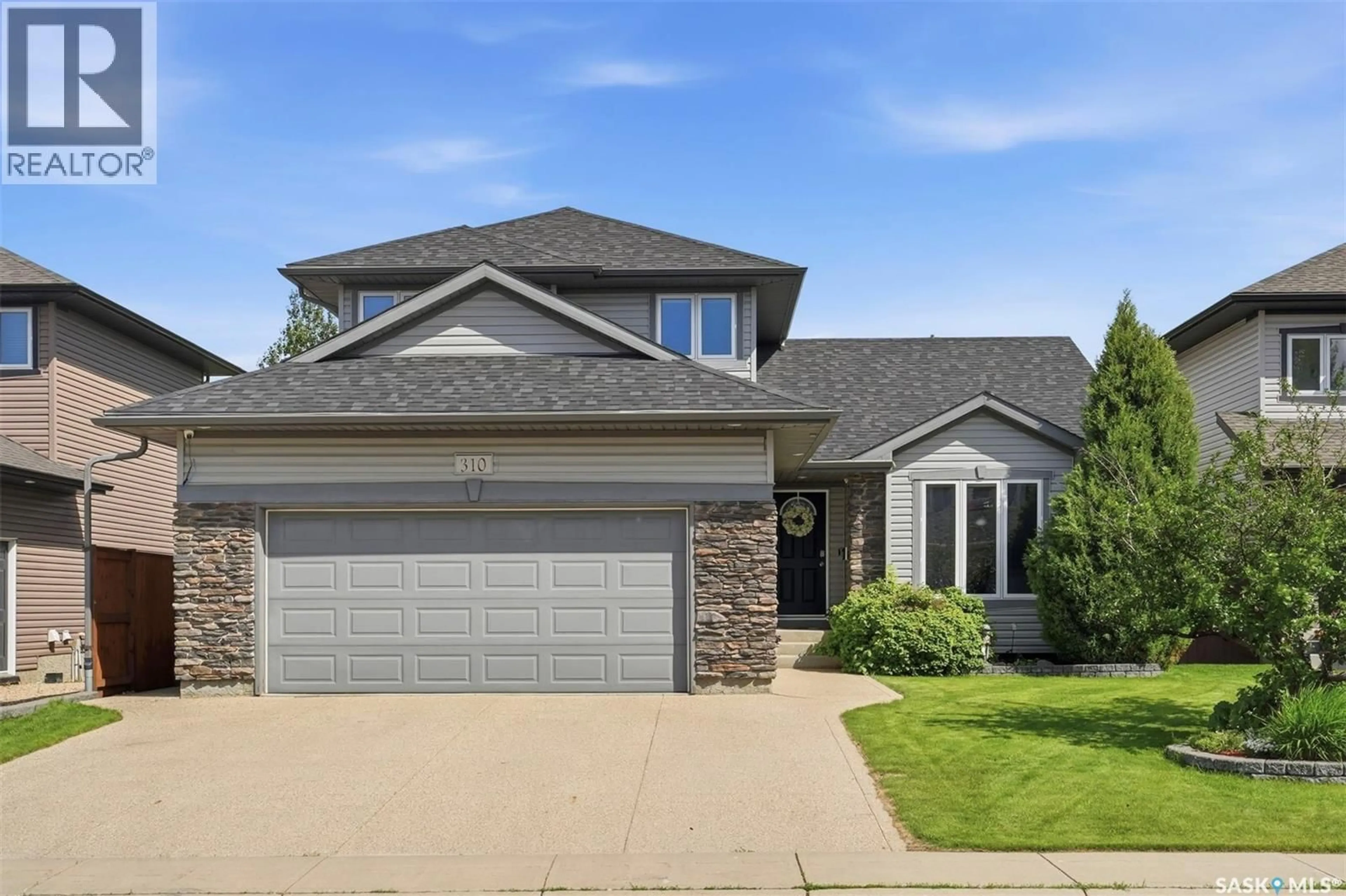 Home with brick exterior material, street for 310 BORLASE COVE, Saskatoon Saskatchewan S7T0B7