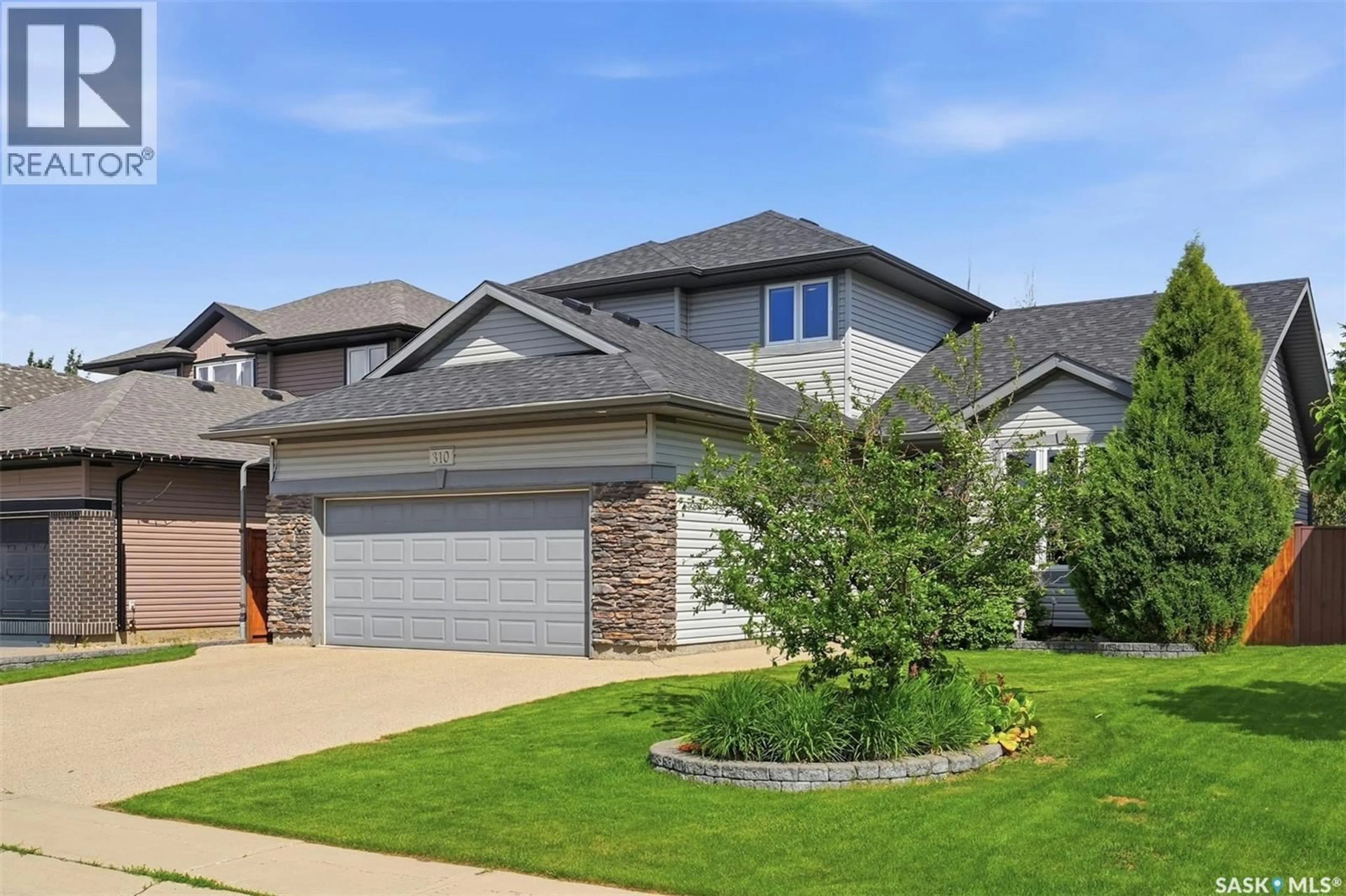 Home with brick exterior material, street for 310 BORLASE COVE, Saskatoon Saskatchewan S7T0B7