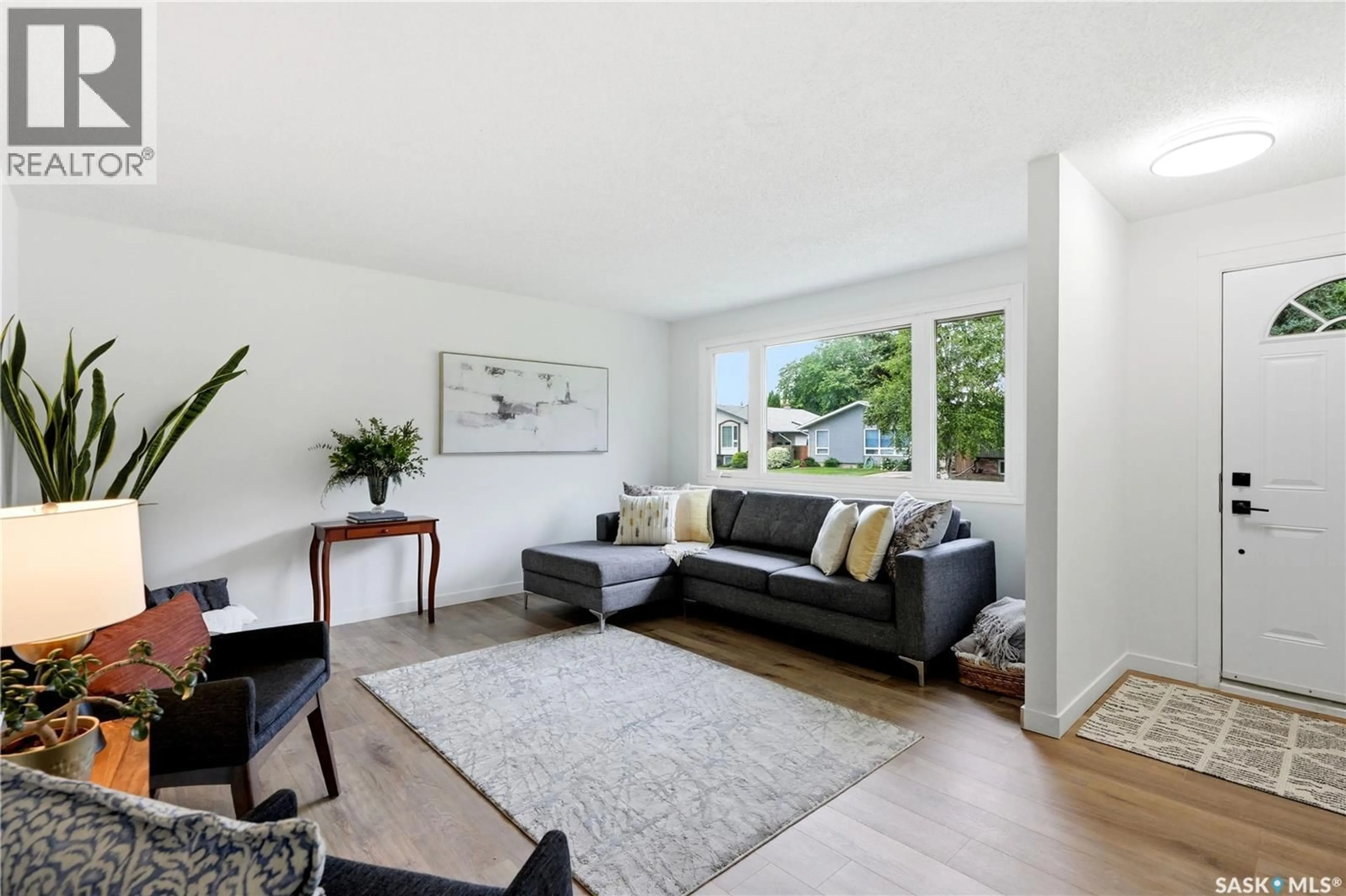 Living room with furniture, wood/laminate floor for 130 BIRCH CRESCENT, Saskatoon Saskatchewan S7N2M3
