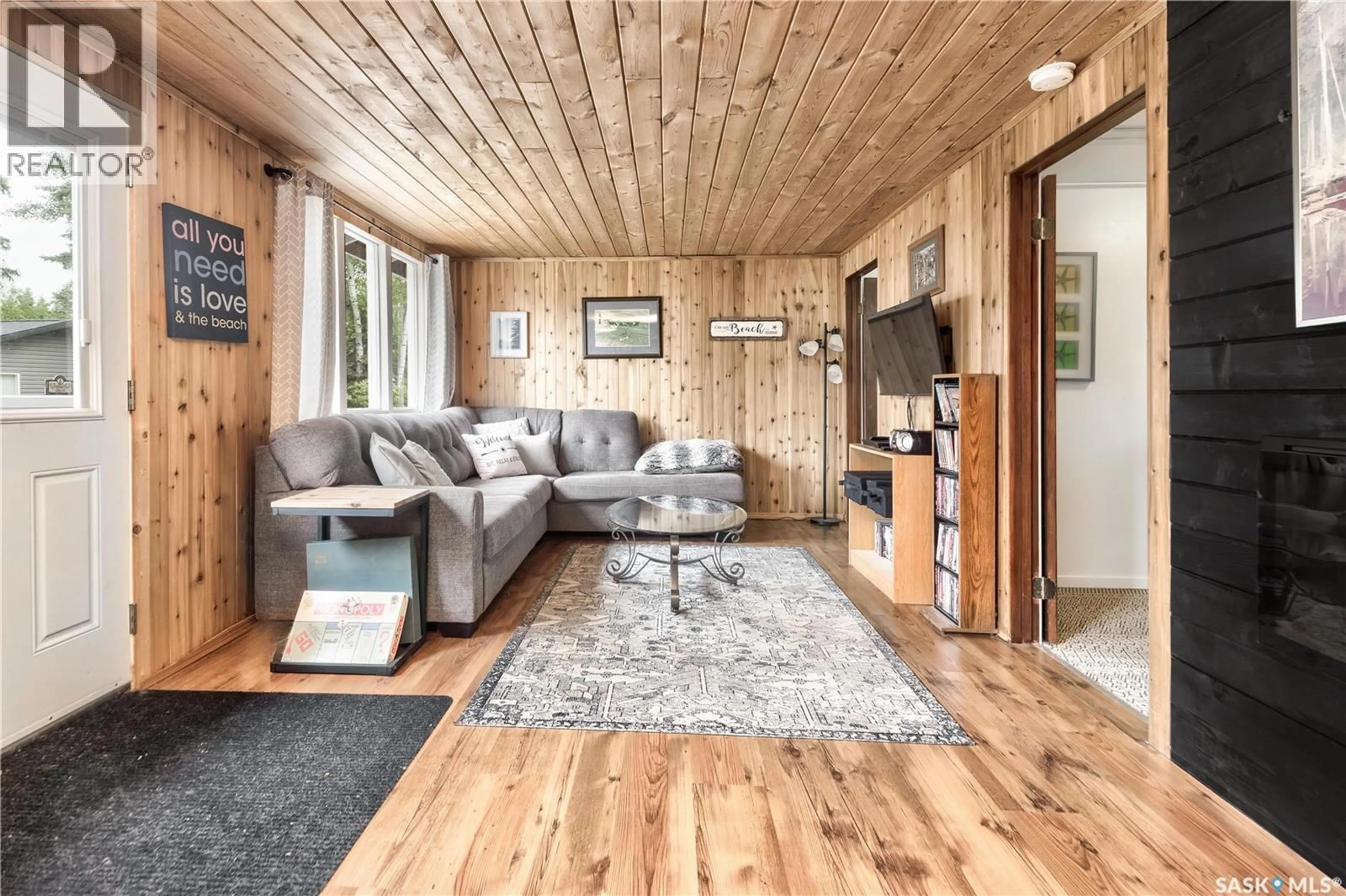 Living room with furniture, wood/laminate floor for 7 8TH STREET, Emma Lake Saskatchewan S0J0N0