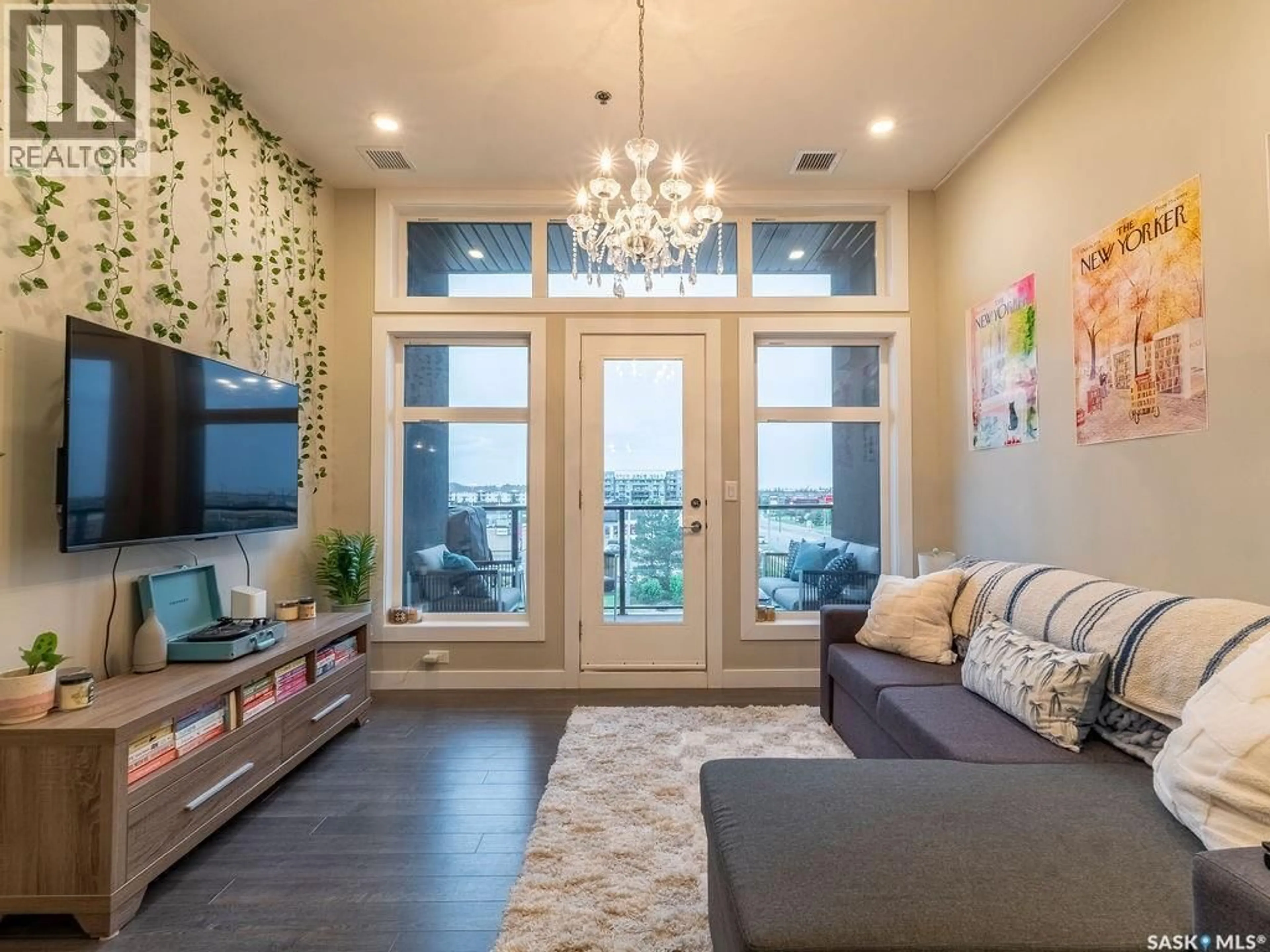 Living room with furniture, wood/laminate floor for 502 - 310 PEREHUDOFF CRESCENT, Saskatoon Saskatchewan S7N0T6