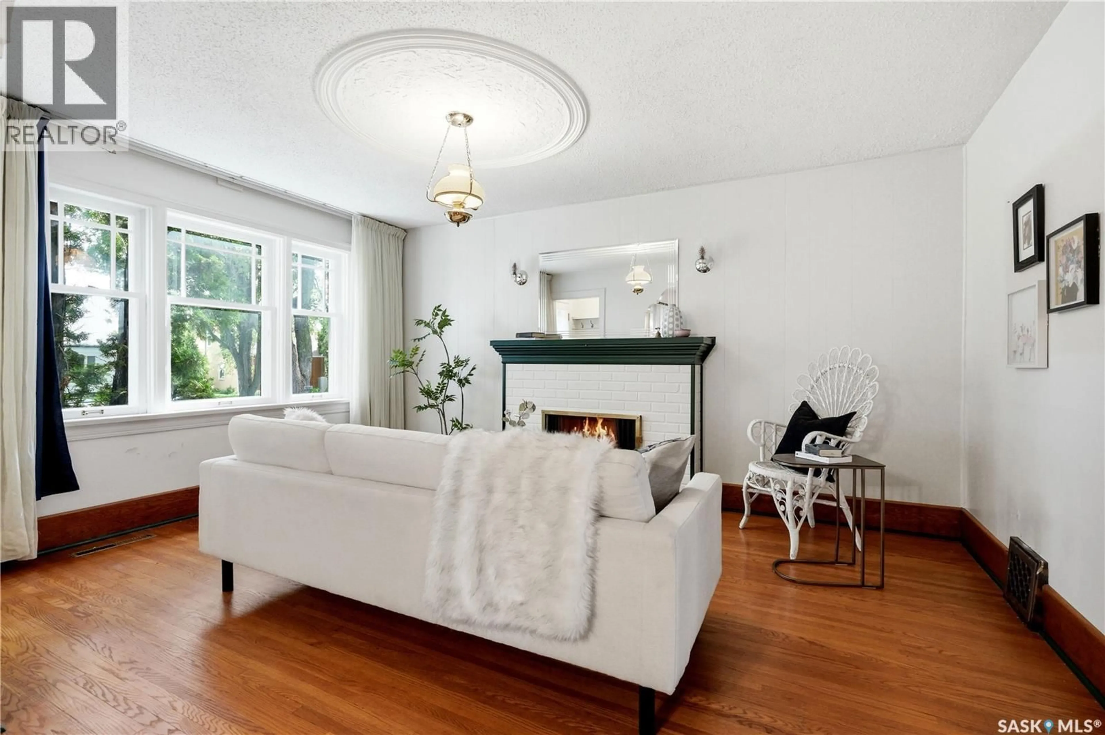 Living room with furniture, wood/laminate floor for 525 5TH STREET, Saskatoon Saskatchewan S7H1G2