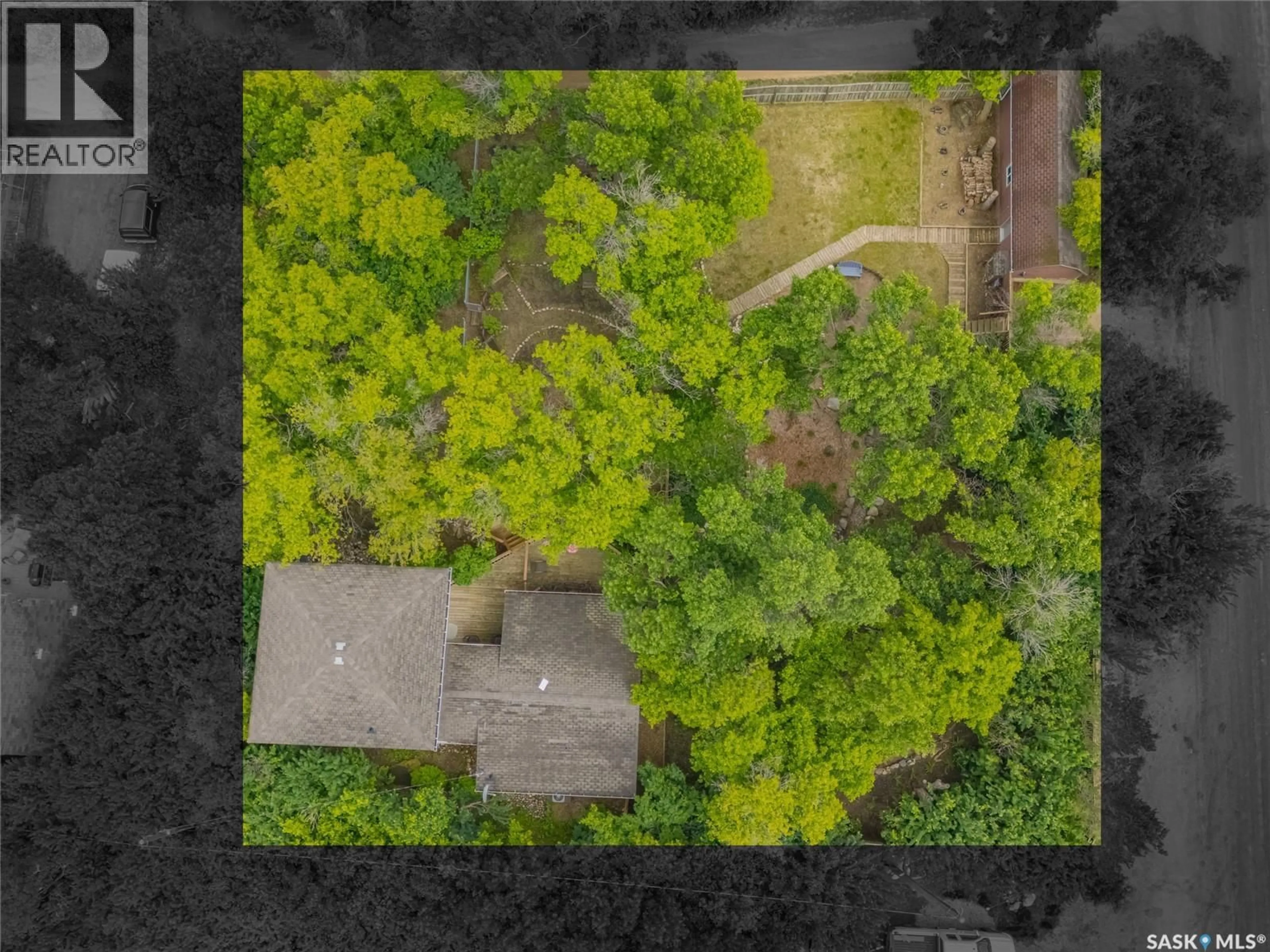 A pic from outside/outdoor area/front of a property/back of a property/a pic from drone, forest/trees view for 215 REGINA STREET, Manitou Beach Saskatchewan S0K4T1