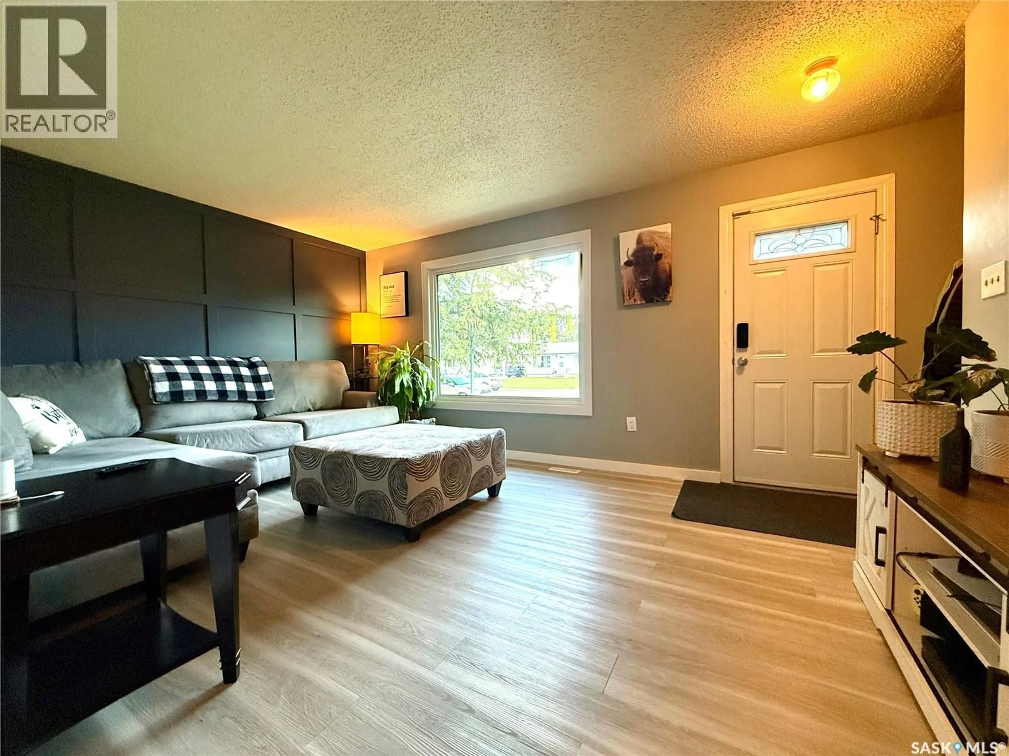 Living room with furniture, wood/laminate floor for 92 REDWOOD DRIVE, Yorkton Saskatchewan S3N2X7