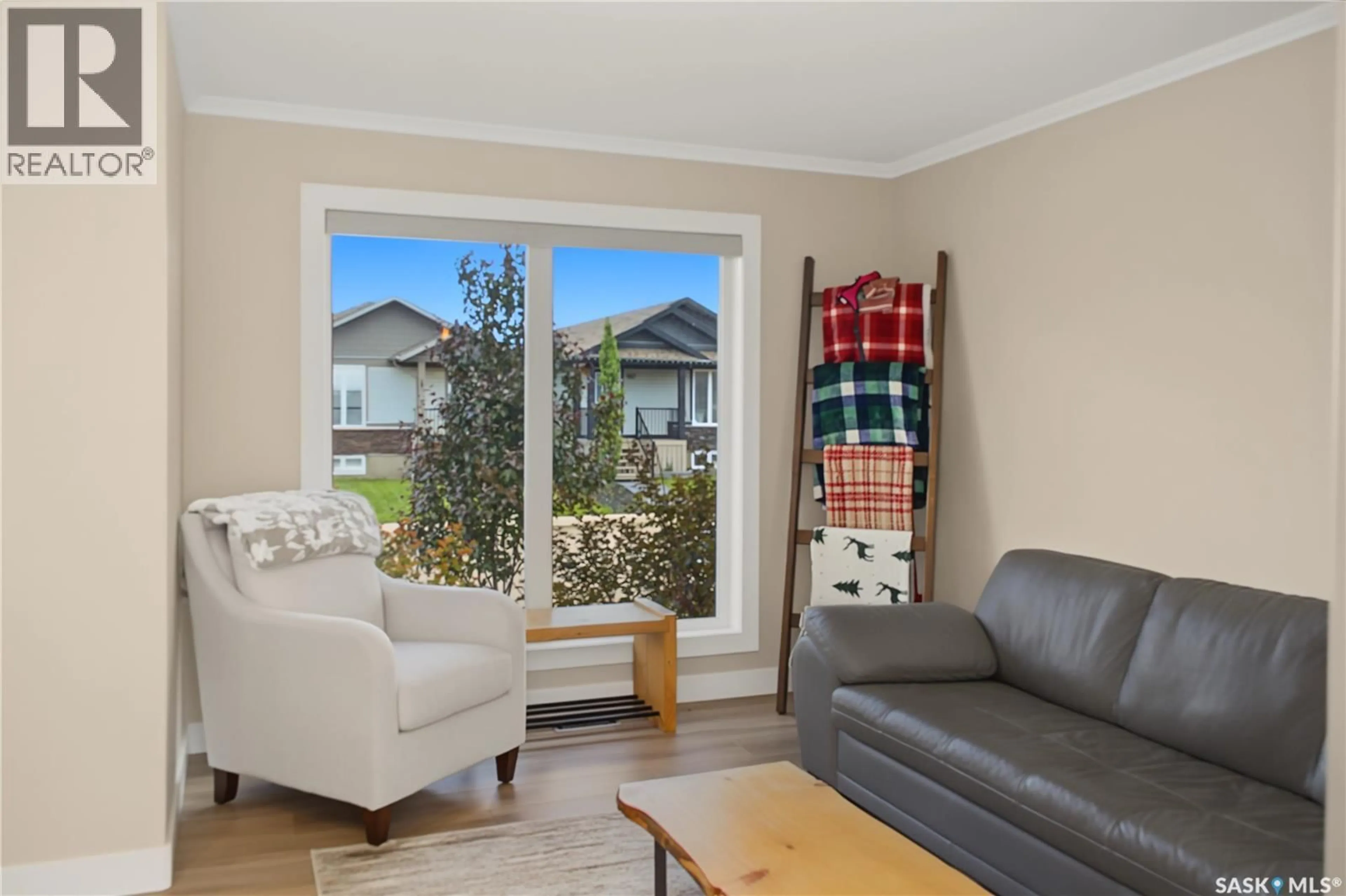 Living room with furniture, wood/laminate floor for 944 GLENVIEW COVE, Martensville Saskatchewan S0K0A2