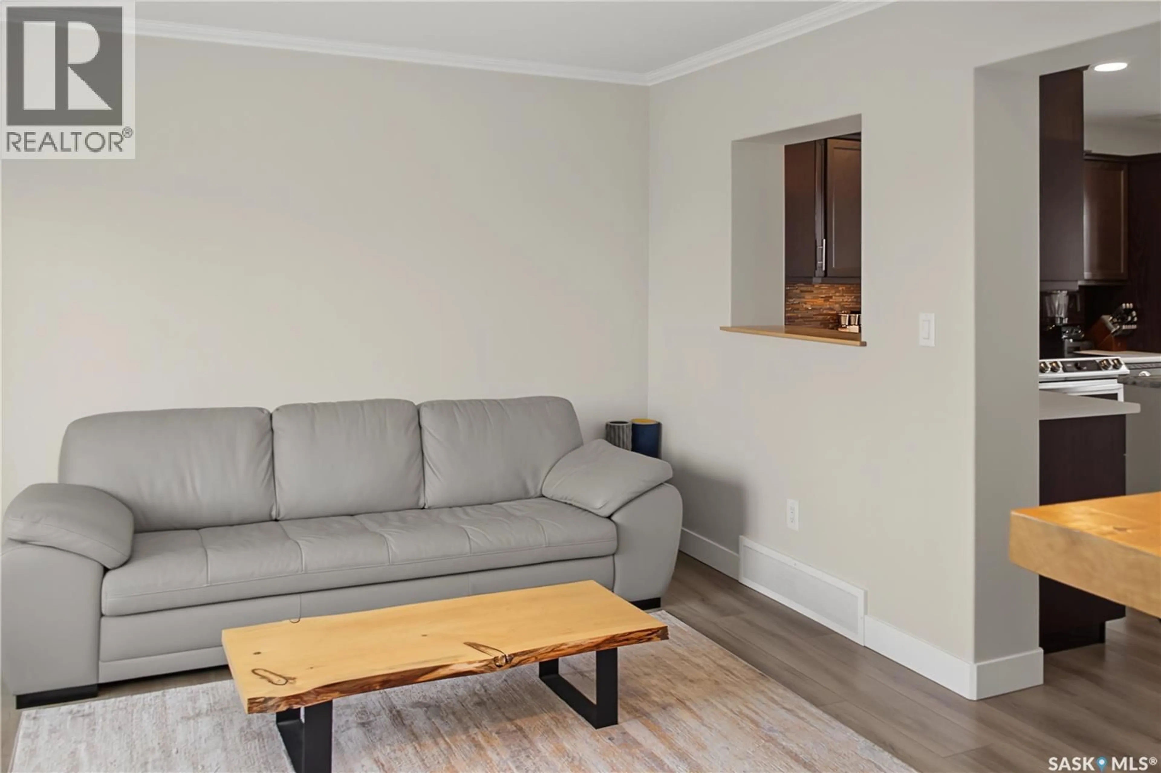 Living room with furniture, wood/laminate floor for 944 GLENVIEW COVE, Martensville Saskatchewan S0K0A2