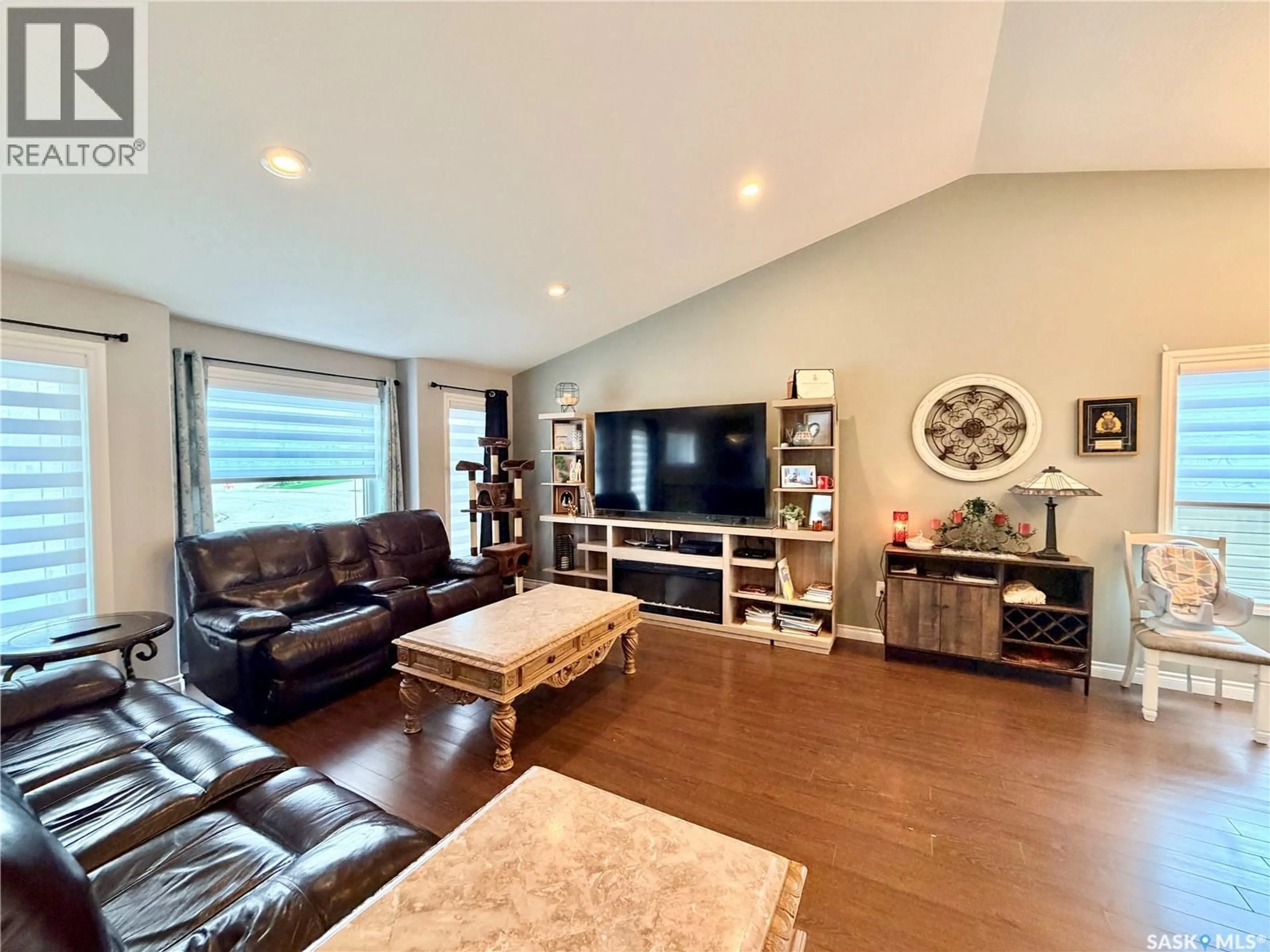 Living room with furniture, wood/laminate floor for 2326 BUHLER BAY, North Battleford Saskatchewan S9A1J2