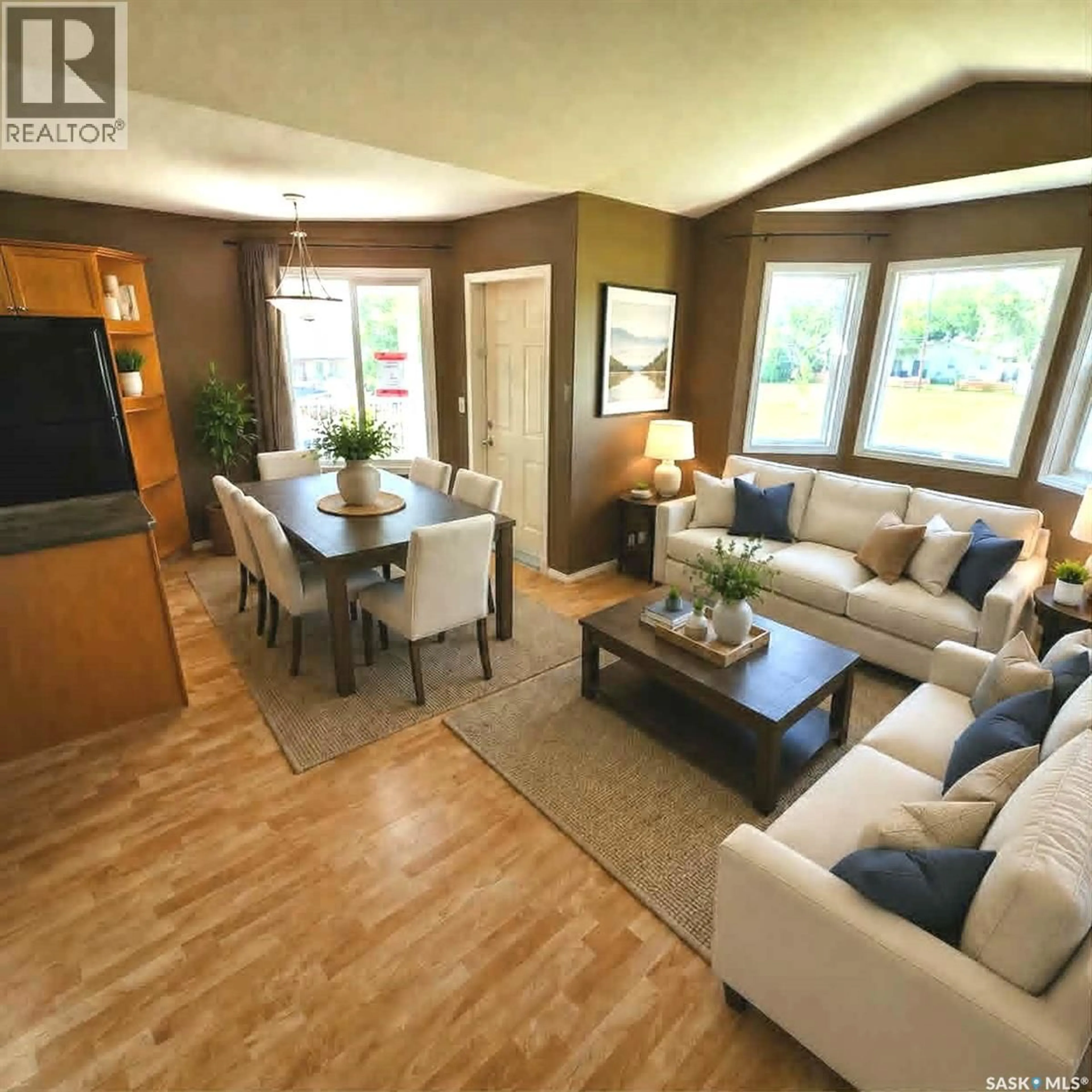 Living room with furniture, wood/laminate floor for 1075 BIRCHWOOD PLACE, Regina Saskatchewan S4S7L1