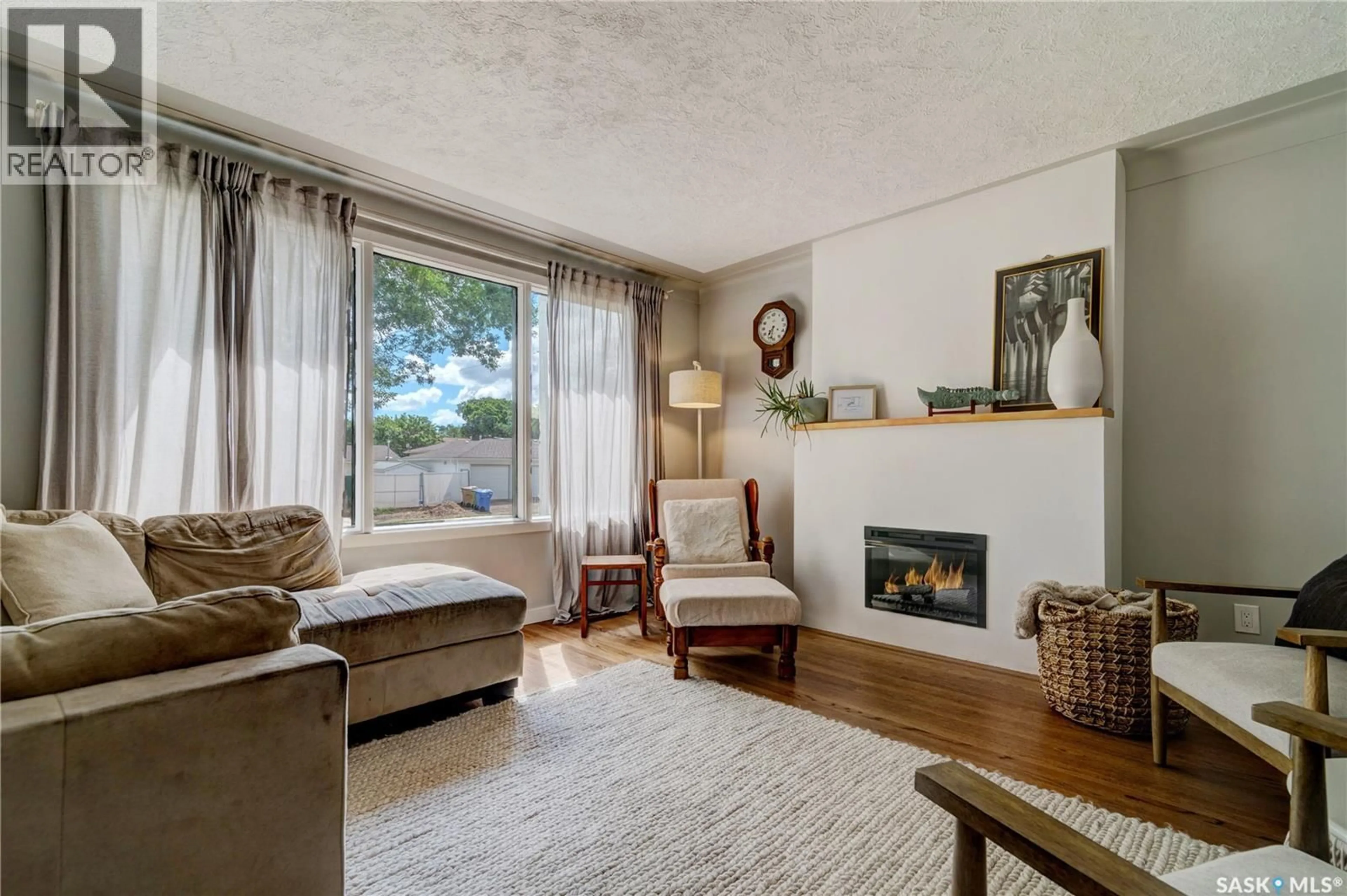 Living room with furniture, wood/laminate floor for 2552 ELLIOTT STREET, Regina Saskatchewan S4N3H5