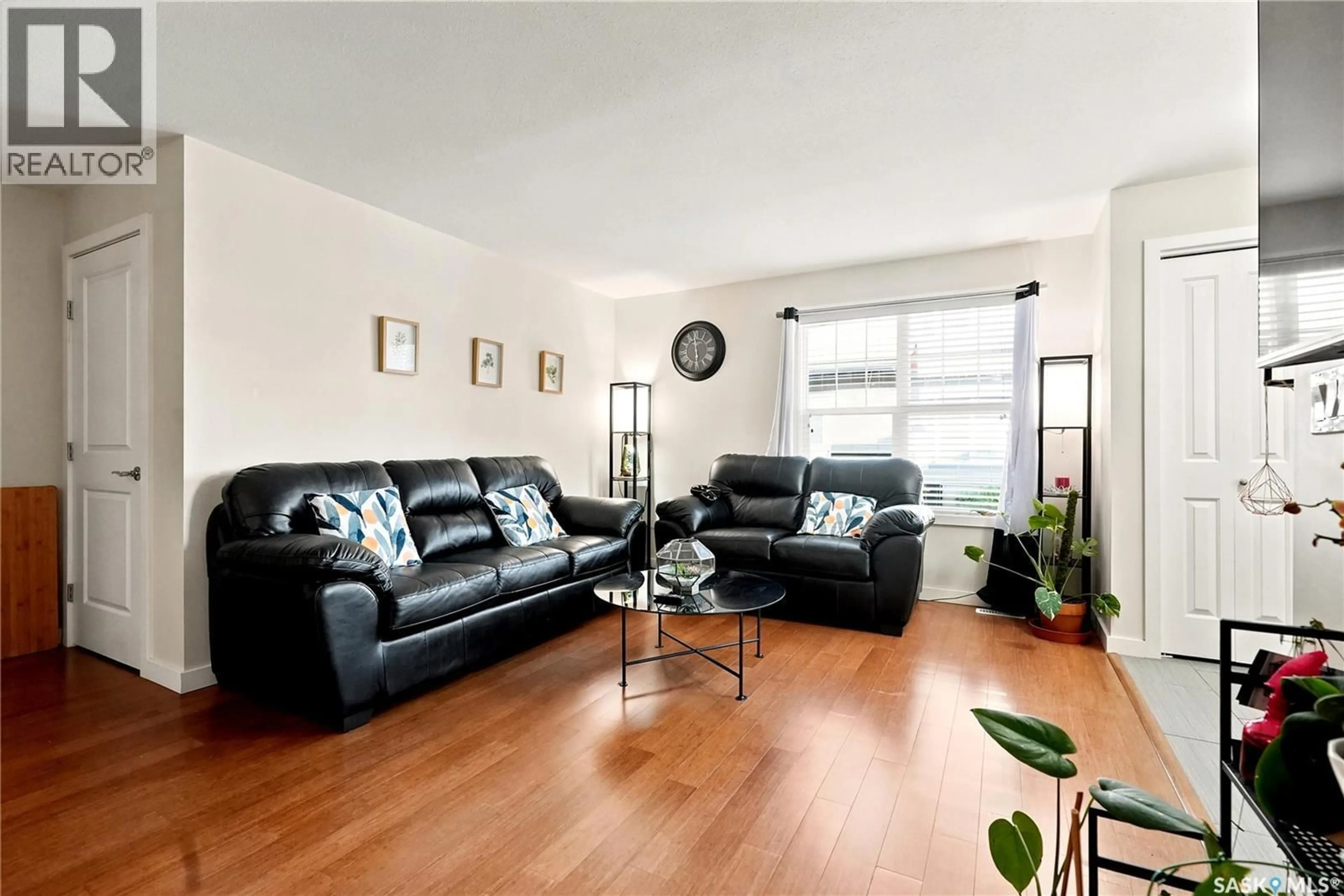 Living room with furniture, wood/laminate floor for 1015 - 909 PATRICK CRESCENT, Saskatoon Saskatchewan S7W0M4