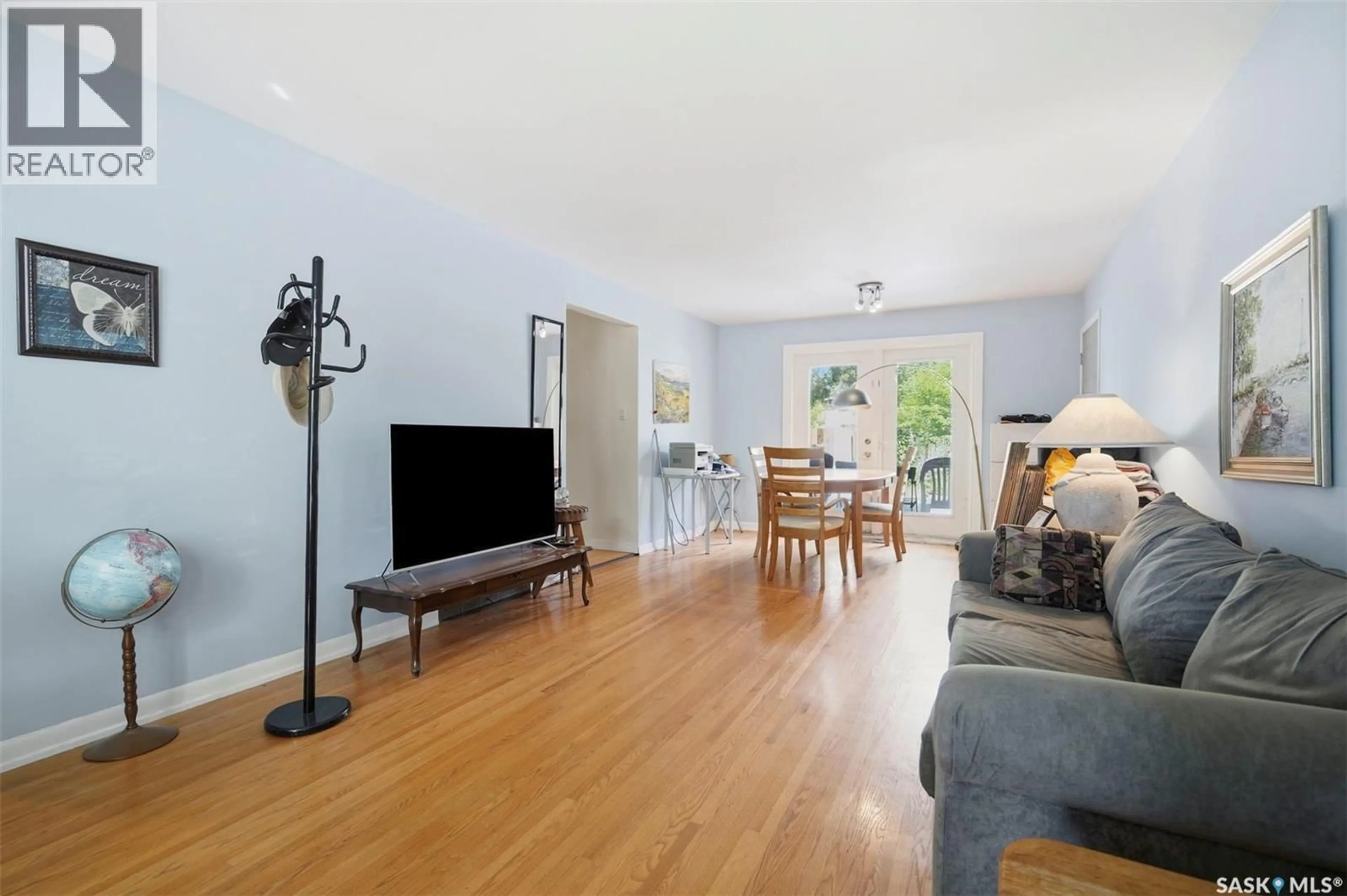 Living room with furniture, wood/laminate floor for 22 RUTTER CRESCENT, Saskatoon Saskatchewan S7H3B7