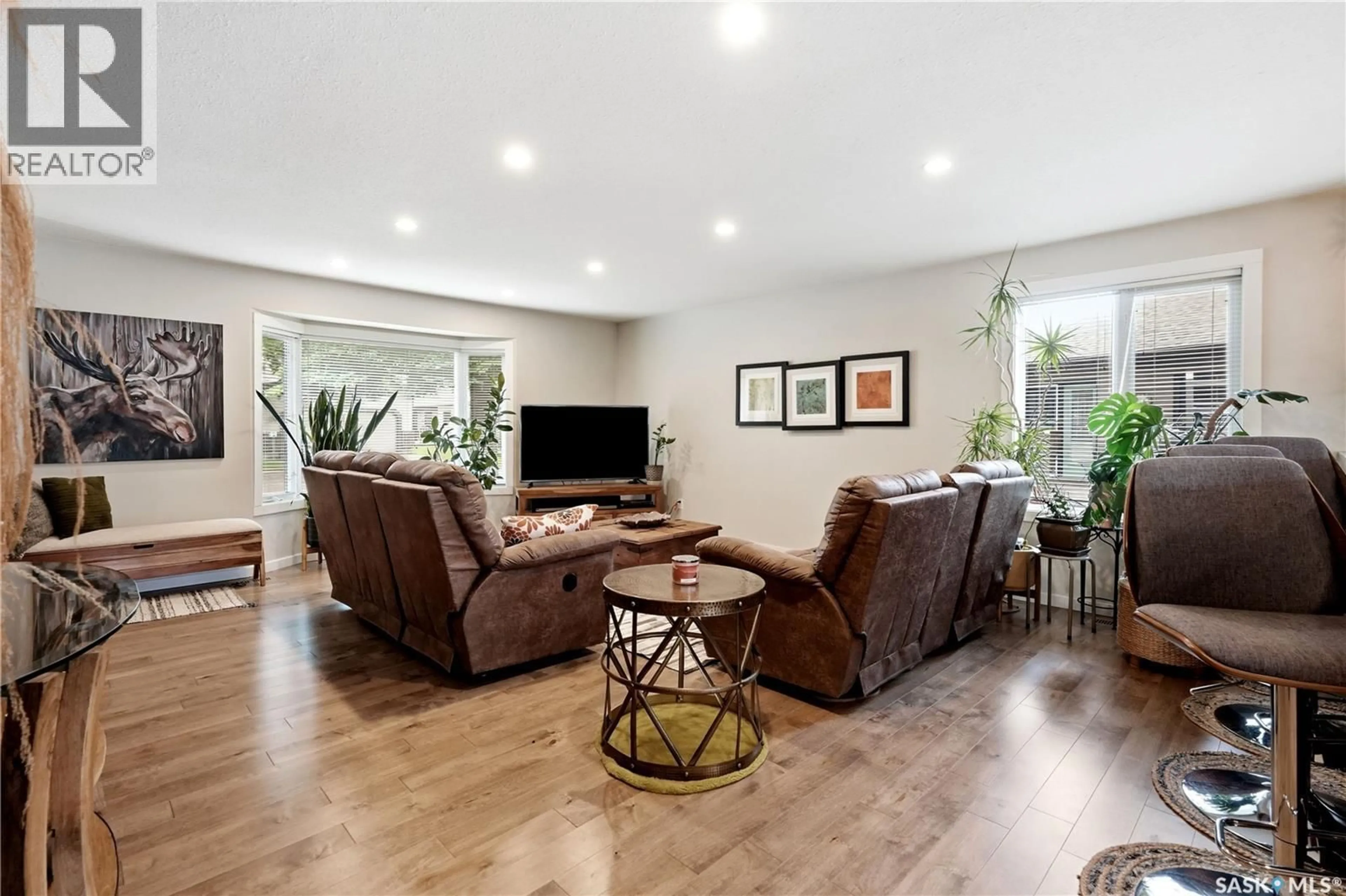 Living room with furniture, wood/laminate floor for 3352 BROOKSHIRE LANE, Regina Saskatchewan S4V2R1