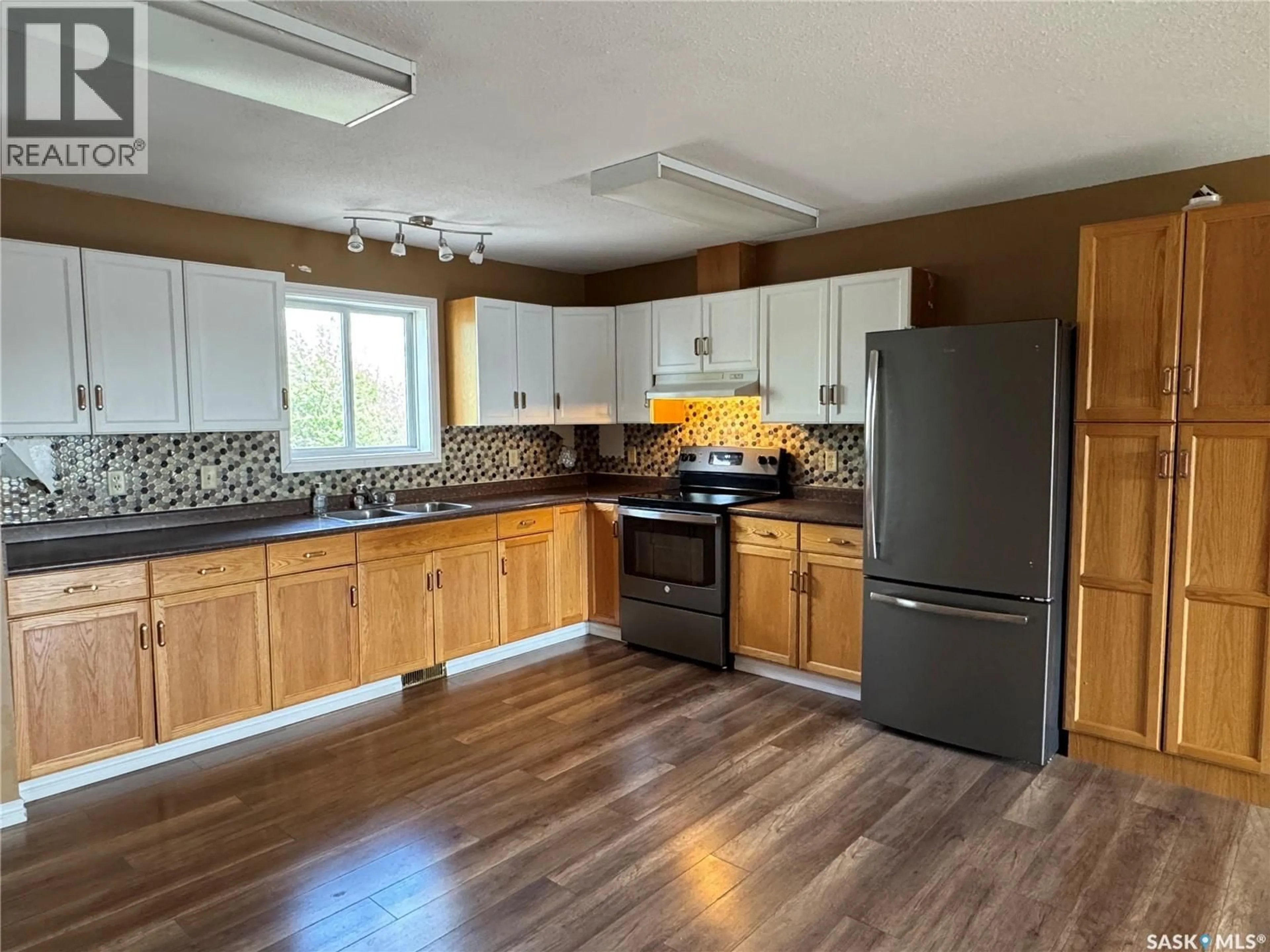 Open concept kitchen, wood/laminate floor for 210 BOUVIER CRESCENT, Beauval Saskatchewan S0M0A1