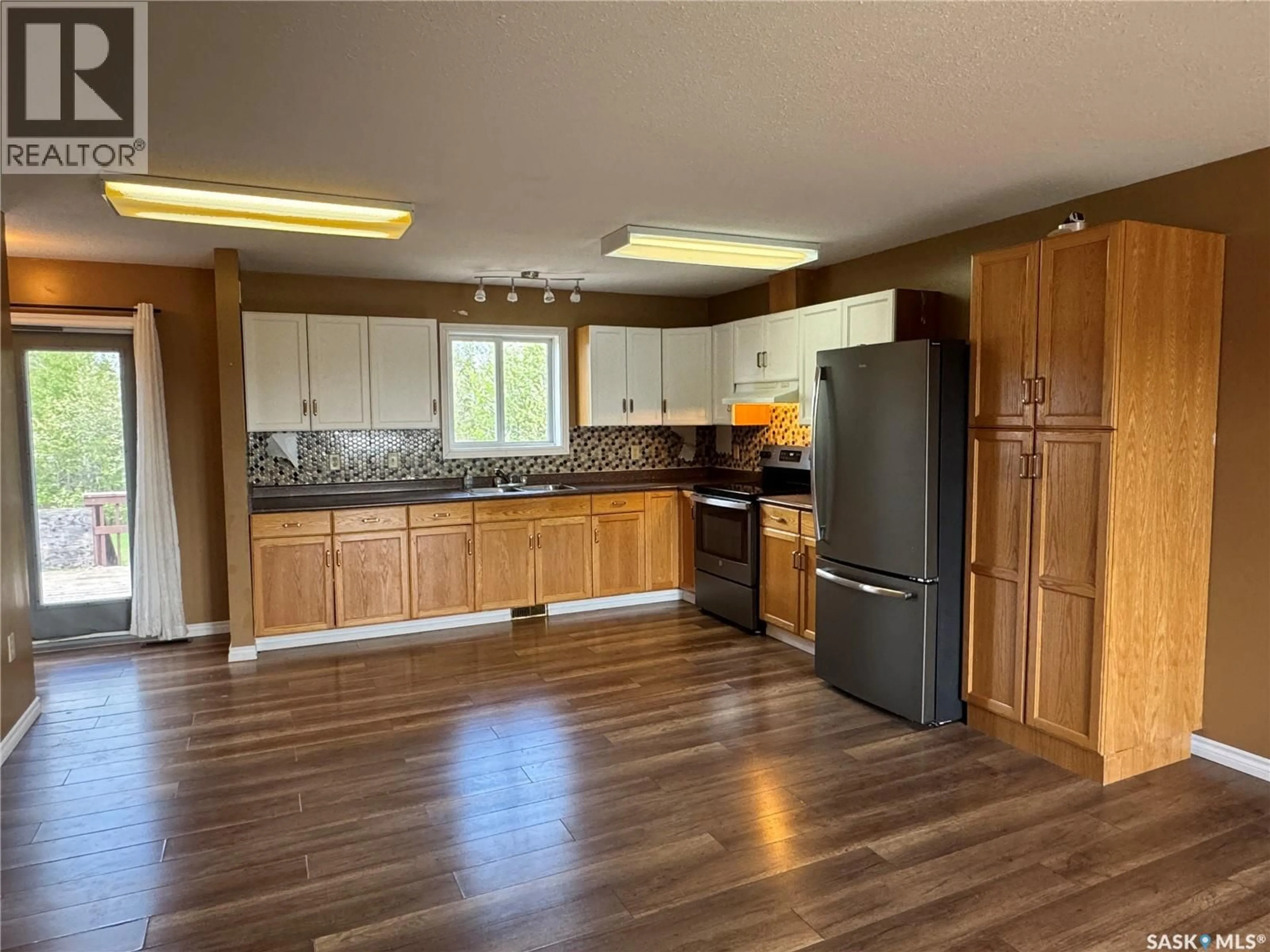 Open concept kitchen, wood/laminate floor for 210 BOUVIER CRESCENT, Beauval Saskatchewan S0M0A1