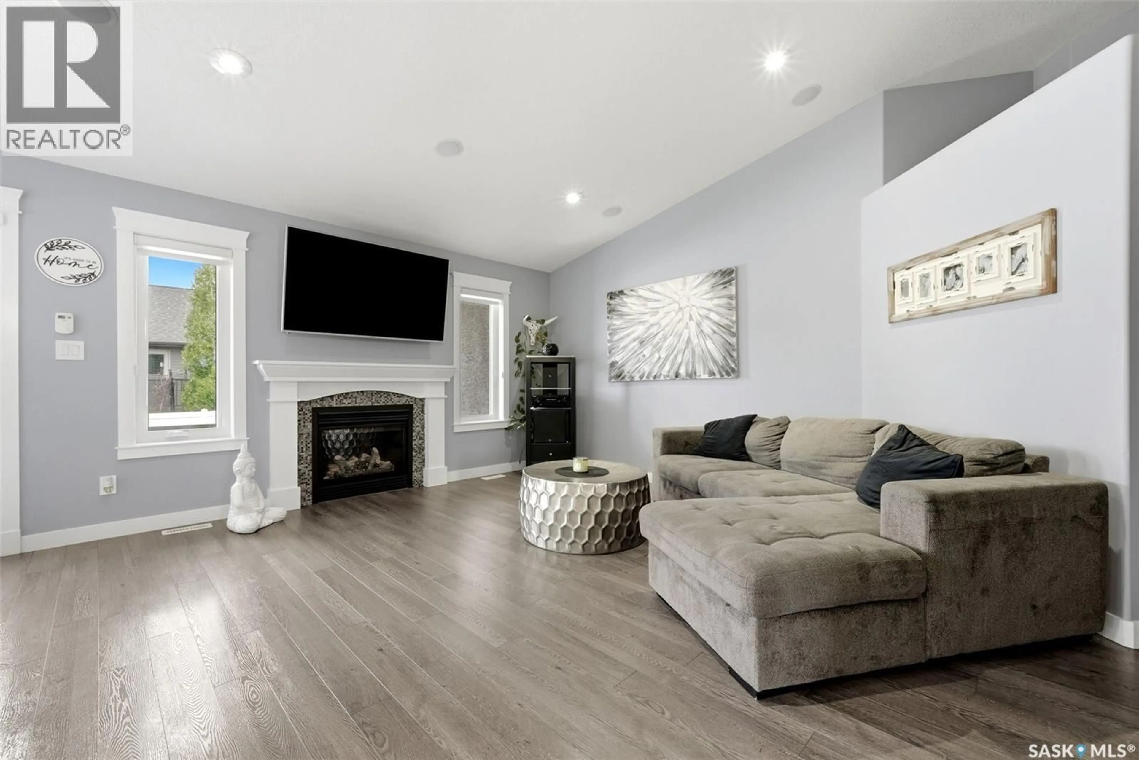 Living room with furniture, wood/laminate floor for 6920 MAPLE RIDGE DRIVE, Regina Saskatchewan S4X0H9