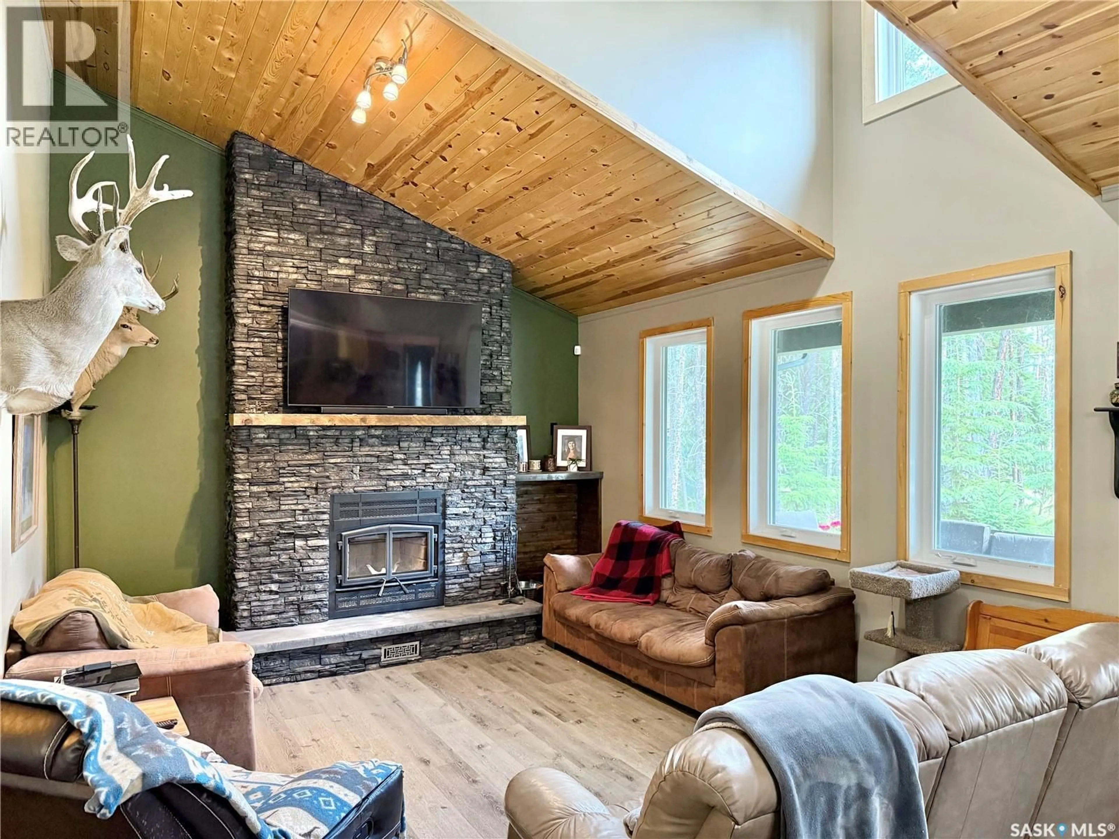 Living room with furniture, wood/laminate floor for 106 DOUGAN COURT, Chitek Lake Saskatchewan S0J0L0