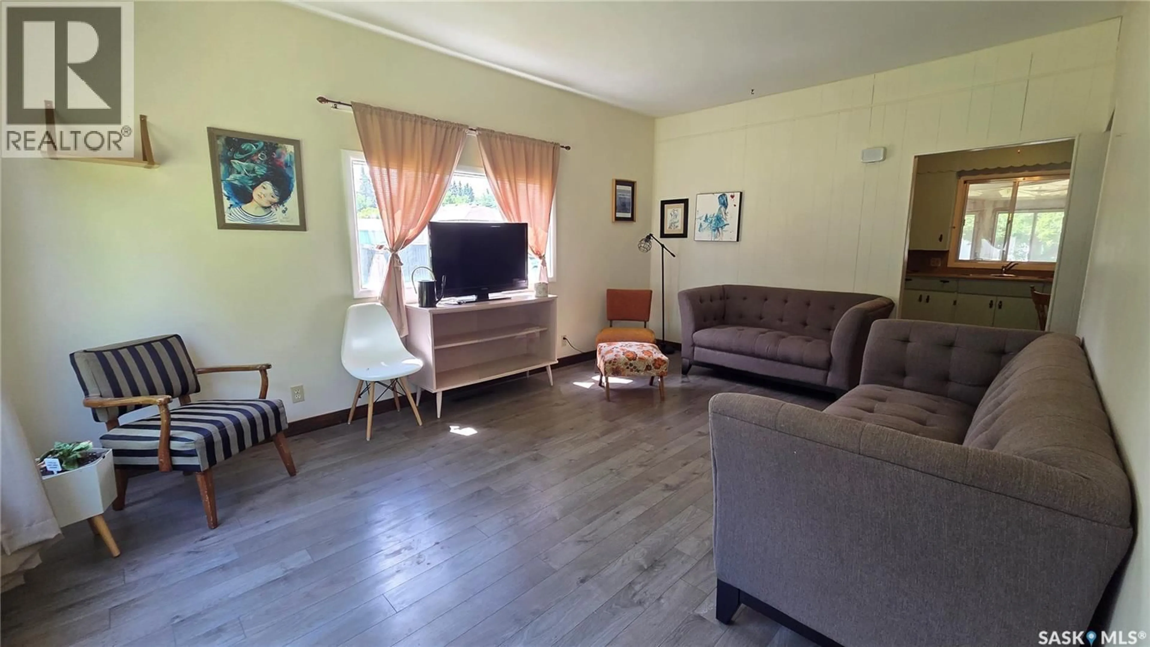 Living room with furniture, wood/laminate floor for 307 1ST STREET, Wilkie Saskatchewan S0K4W0