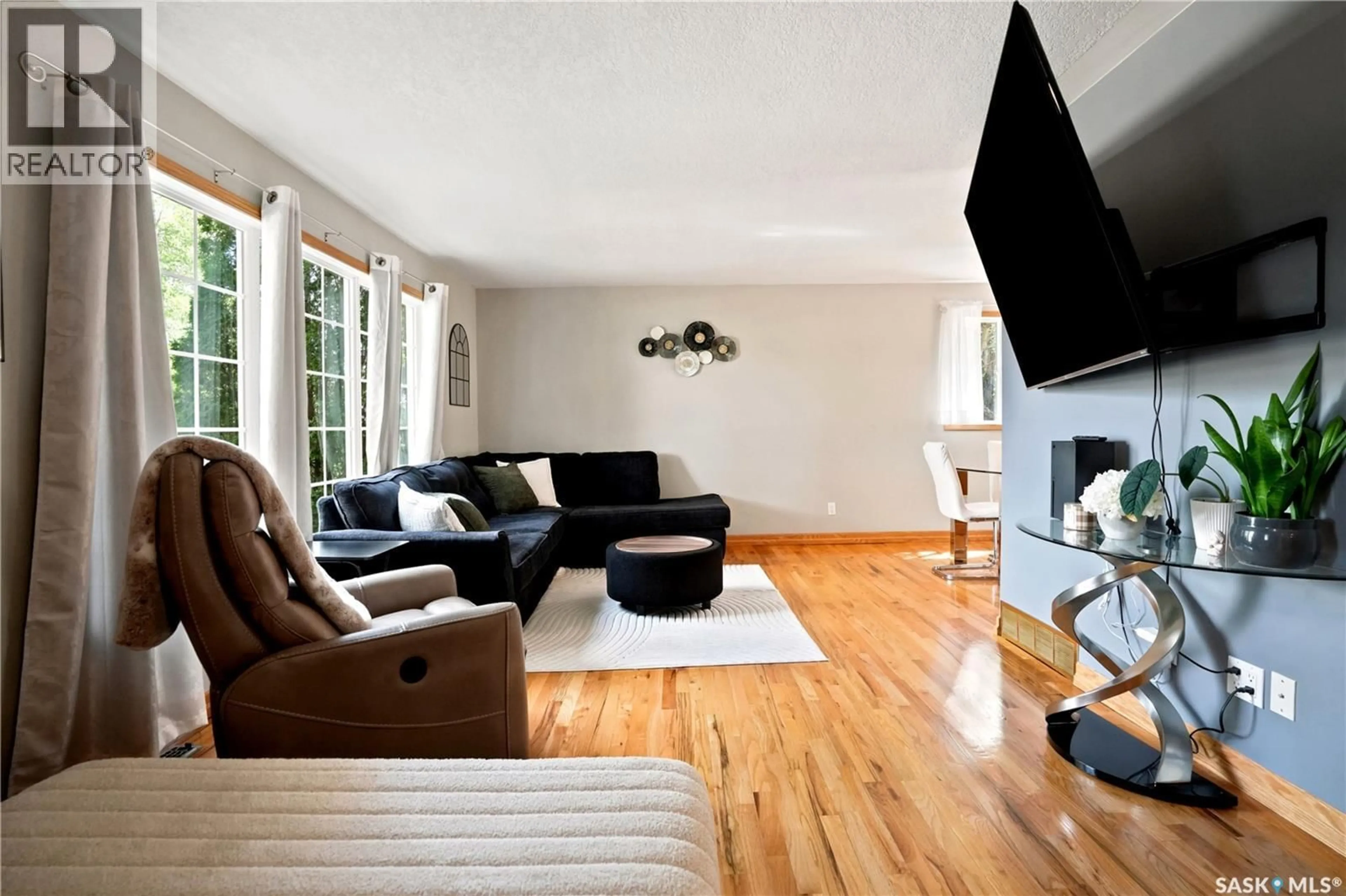 Living room with furniture, wood/laminate floor for 87 YARNTON CRESCENT, Regina Saskatchewan S4R4A4
