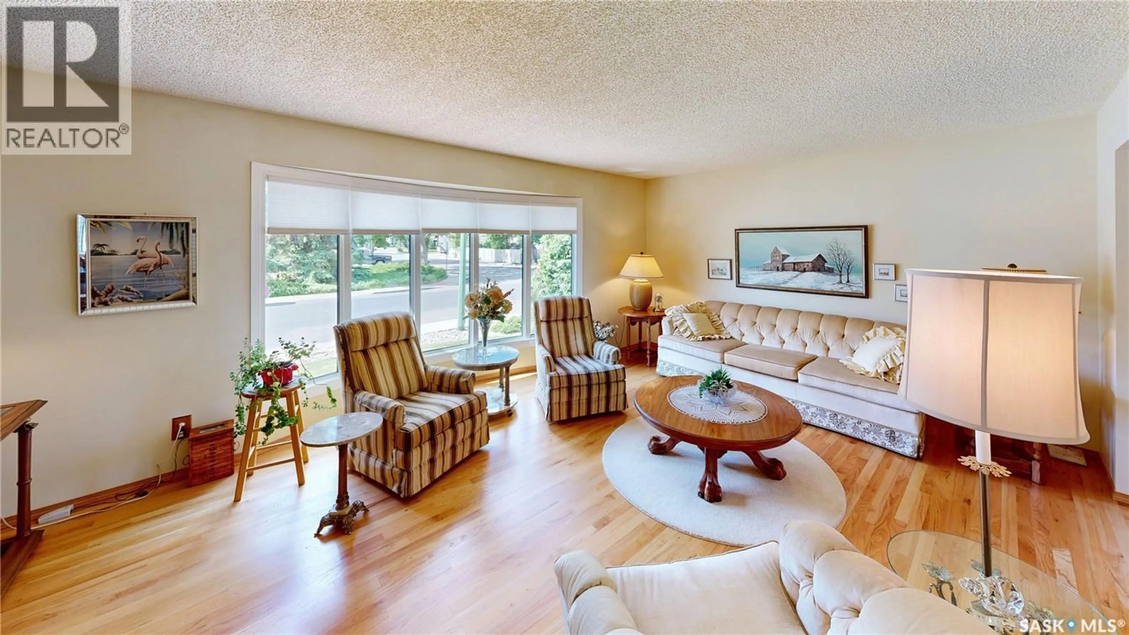 Living room with furniture, wood/laminate floor for 66 SOMMERFELD DRIVE, Regina Saskatchewan S4V0C5