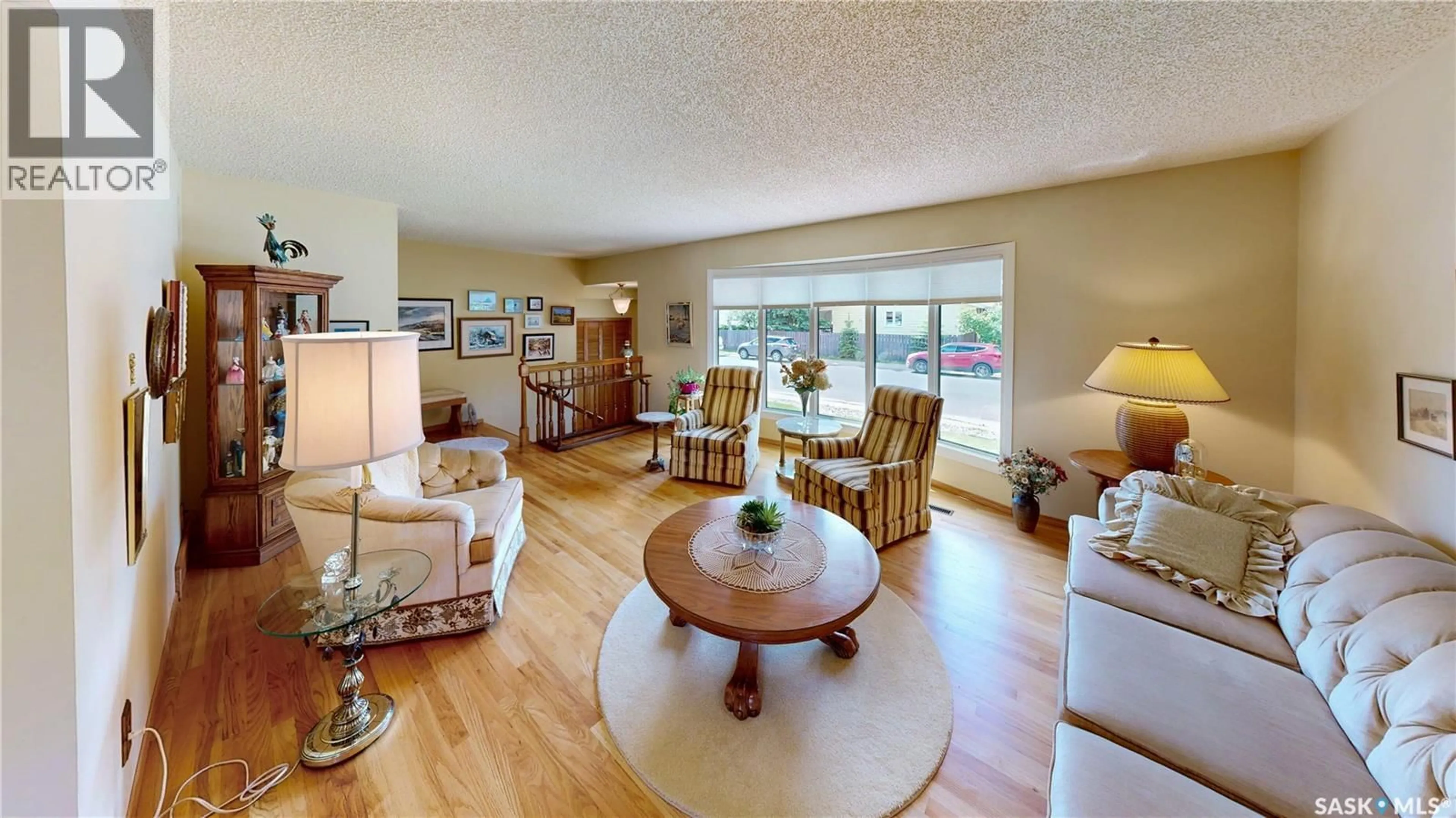 Living room with furniture, wood/laminate floor for 66 SOMMERFELD DRIVE, Regina Saskatchewan S4V0C5