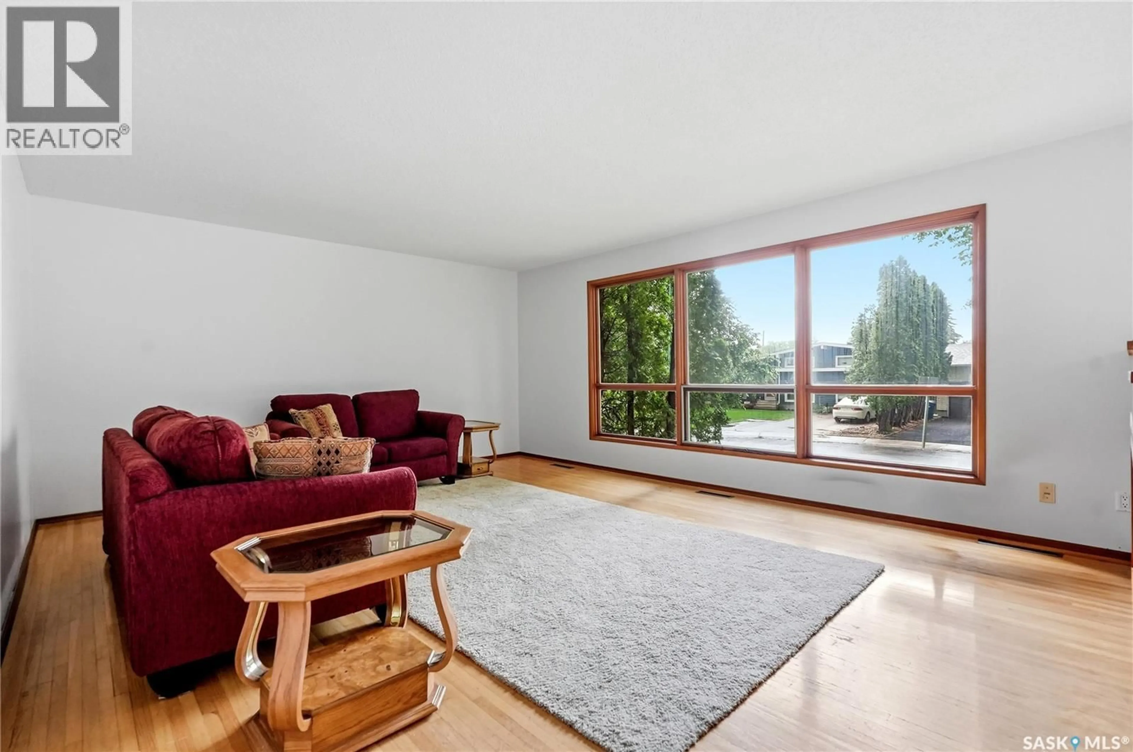 Living room with furniture, wood/laminate floor for 21 BATEMAN CRESCENT, Saskatoon Saskatchewan S7H3C3