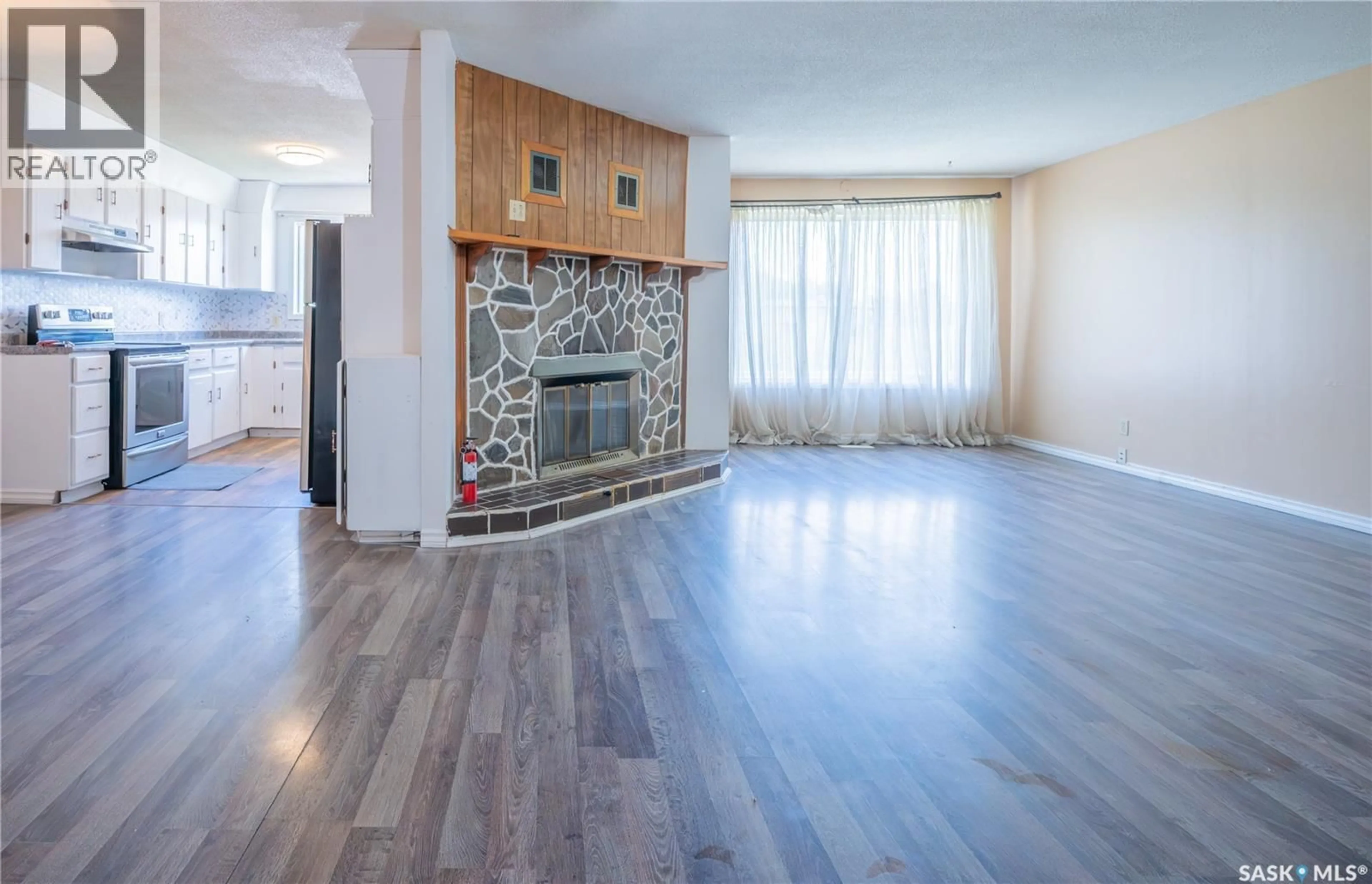 Living room with furniture, wood/laminate floor for 32 CLARKE AVENUE, Yorkton Saskatchewan S3N2M3