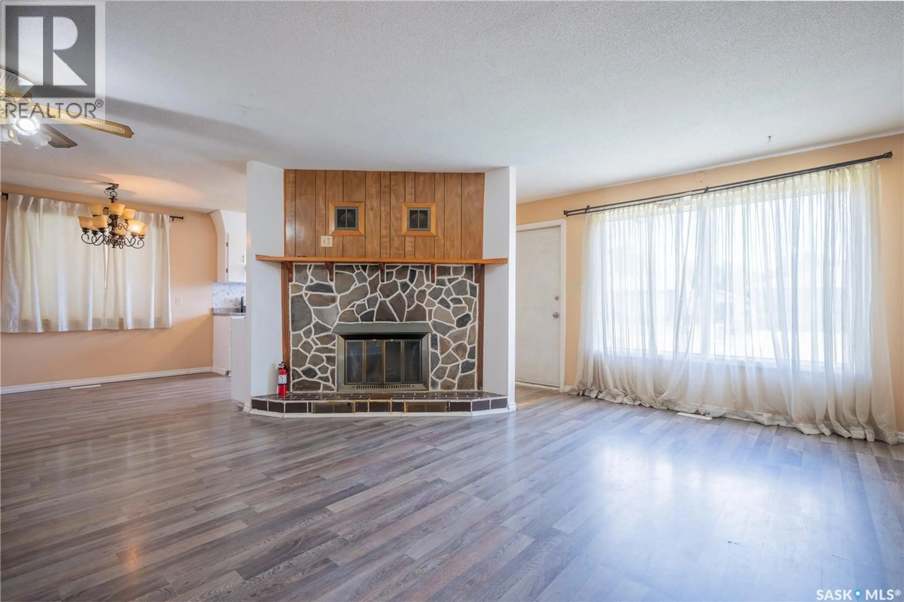 Living room with furniture, wood/laminate floor for 32 CLARKE AVENUE, Yorkton Saskatchewan S3N2M3