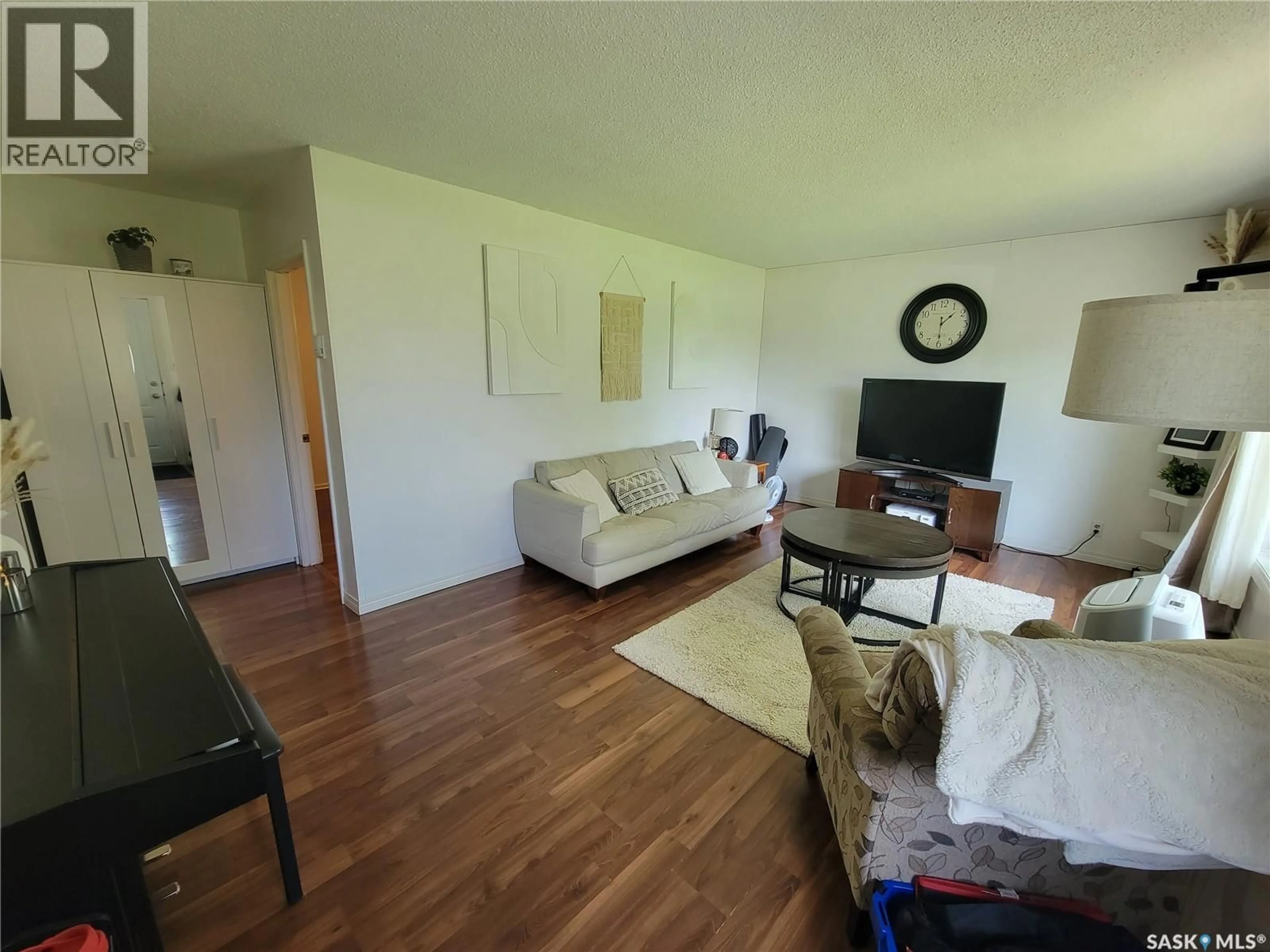 Living room with furniture, wood/laminate floor for 214 5TH STREET, Denzil Saskatchewan S0L0S0
