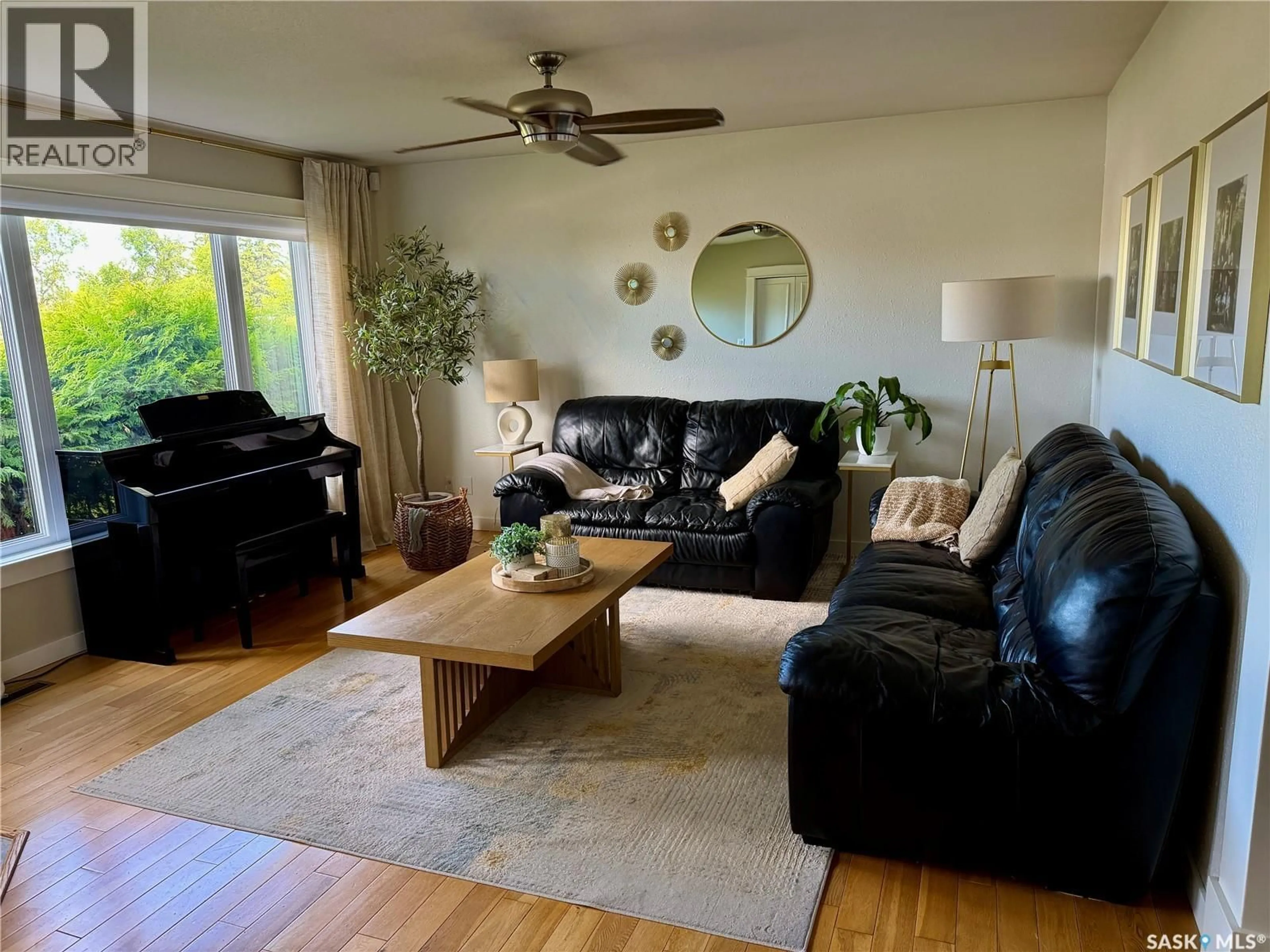 Living room with furniture, wood/laminate floor for 208 JAMES STREET, Langham Saskatchewan S0K2L0