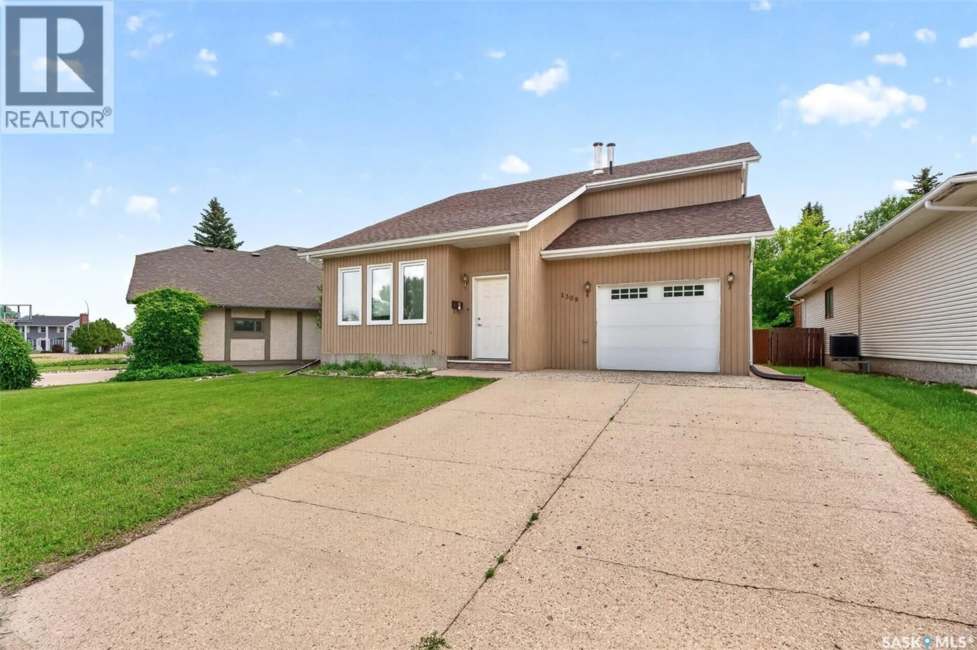 Home with vinyl exterior material, street for 1309 REGAL CRESCENT, Moose Jaw Saskatchewan S6H7S1