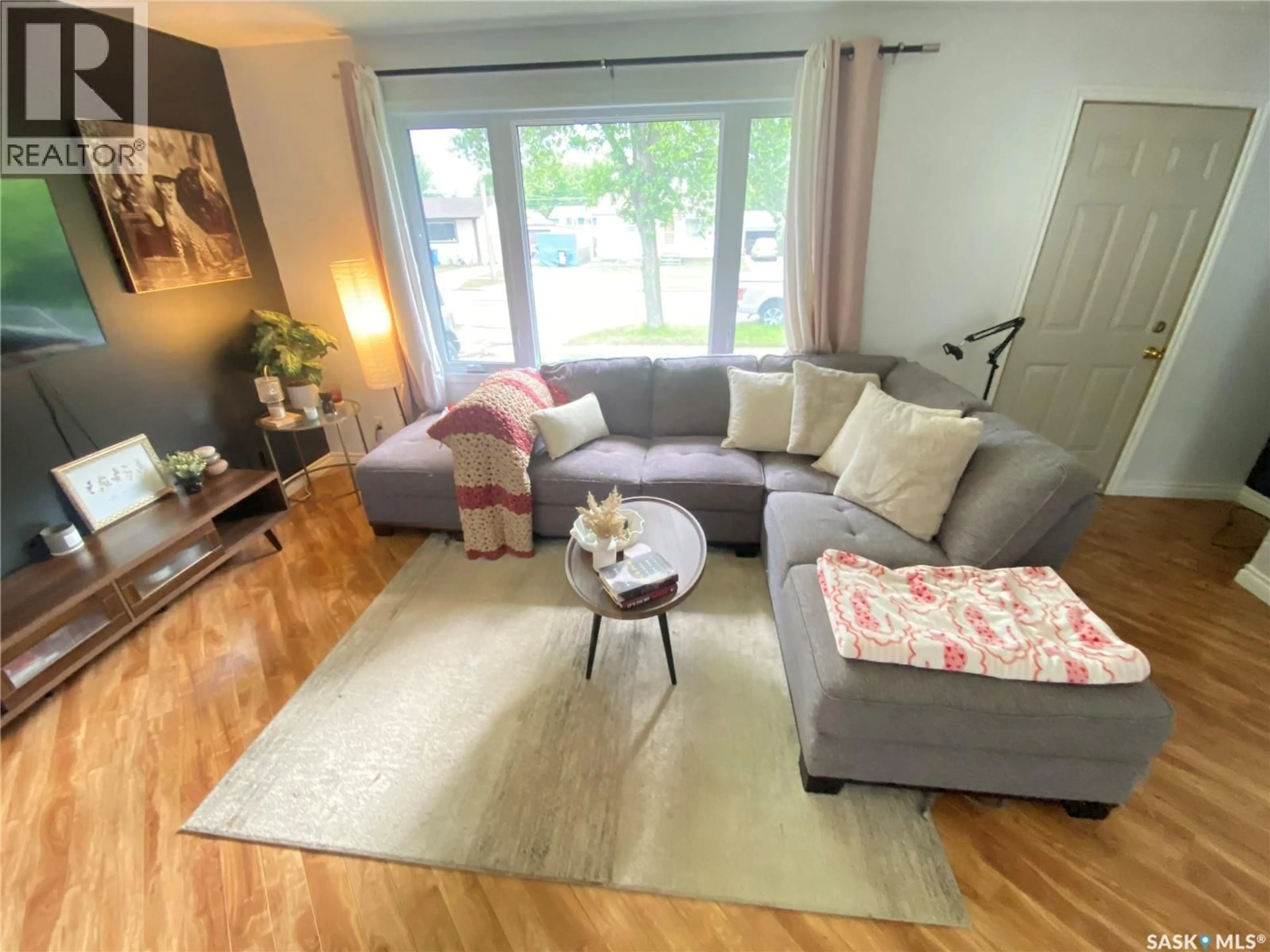 Living room with furniture, wood/laminate floor for 65 IRWIN AVENUE, Yorkton Saskatchewan S3N2E4