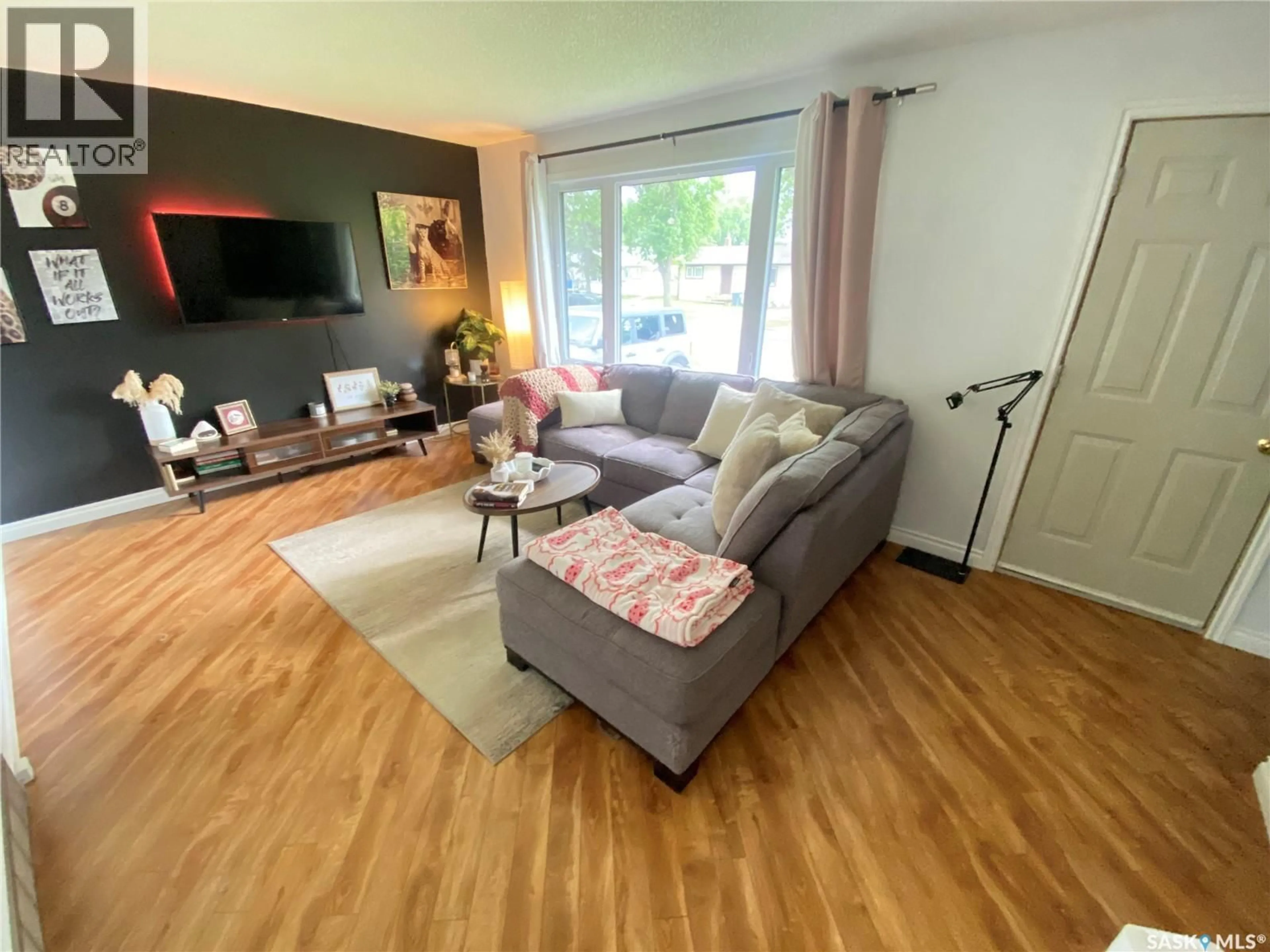 Living room with furniture, wood/laminate floor for 65 IRWIN AVENUE, Yorkton Saskatchewan S3N2E4