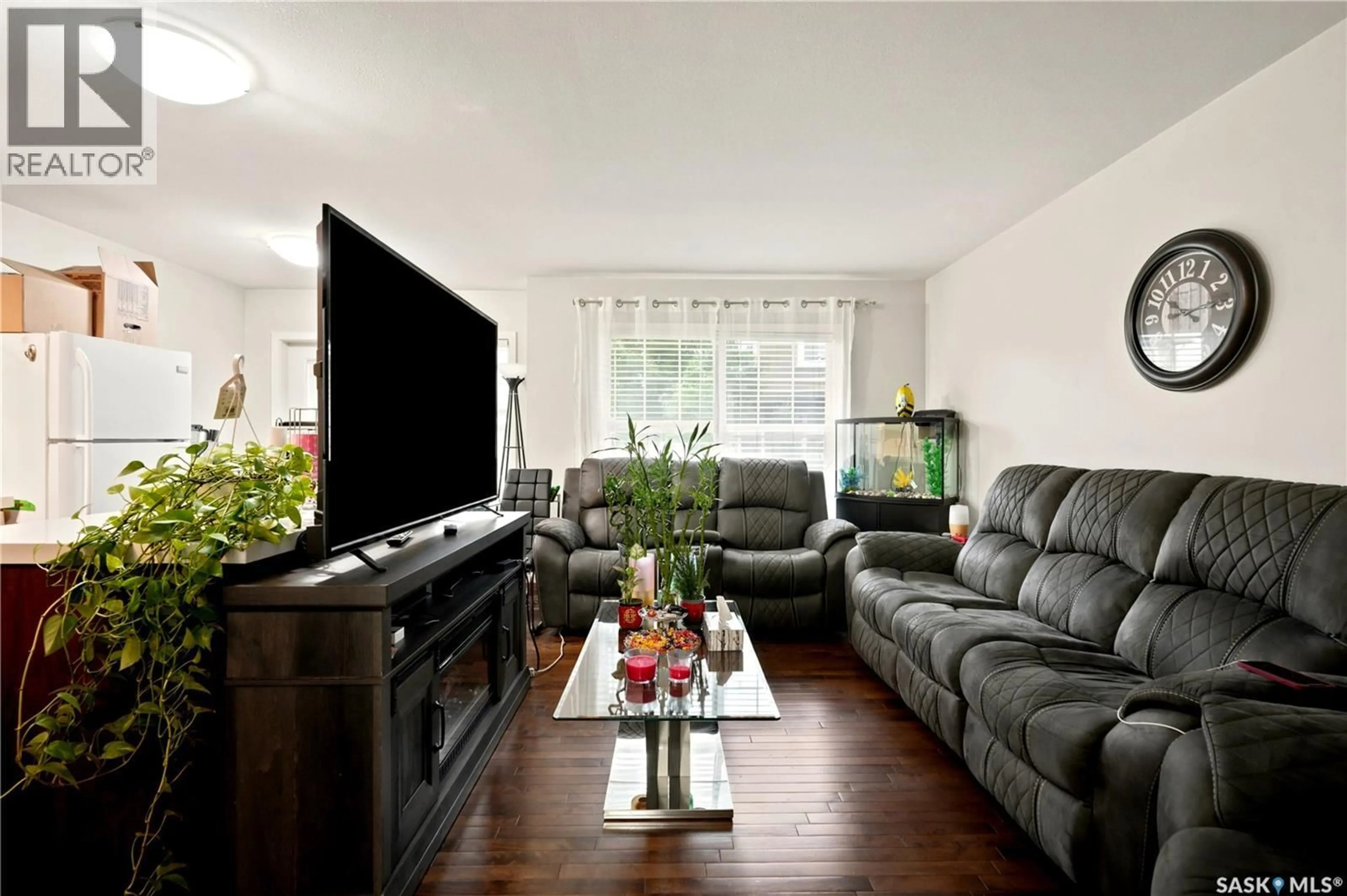 Living room with furniture, wood/laminate floor for 203 - 1555 PATON CRESCENT, Saskatoon Saskatchewan S7W0V5