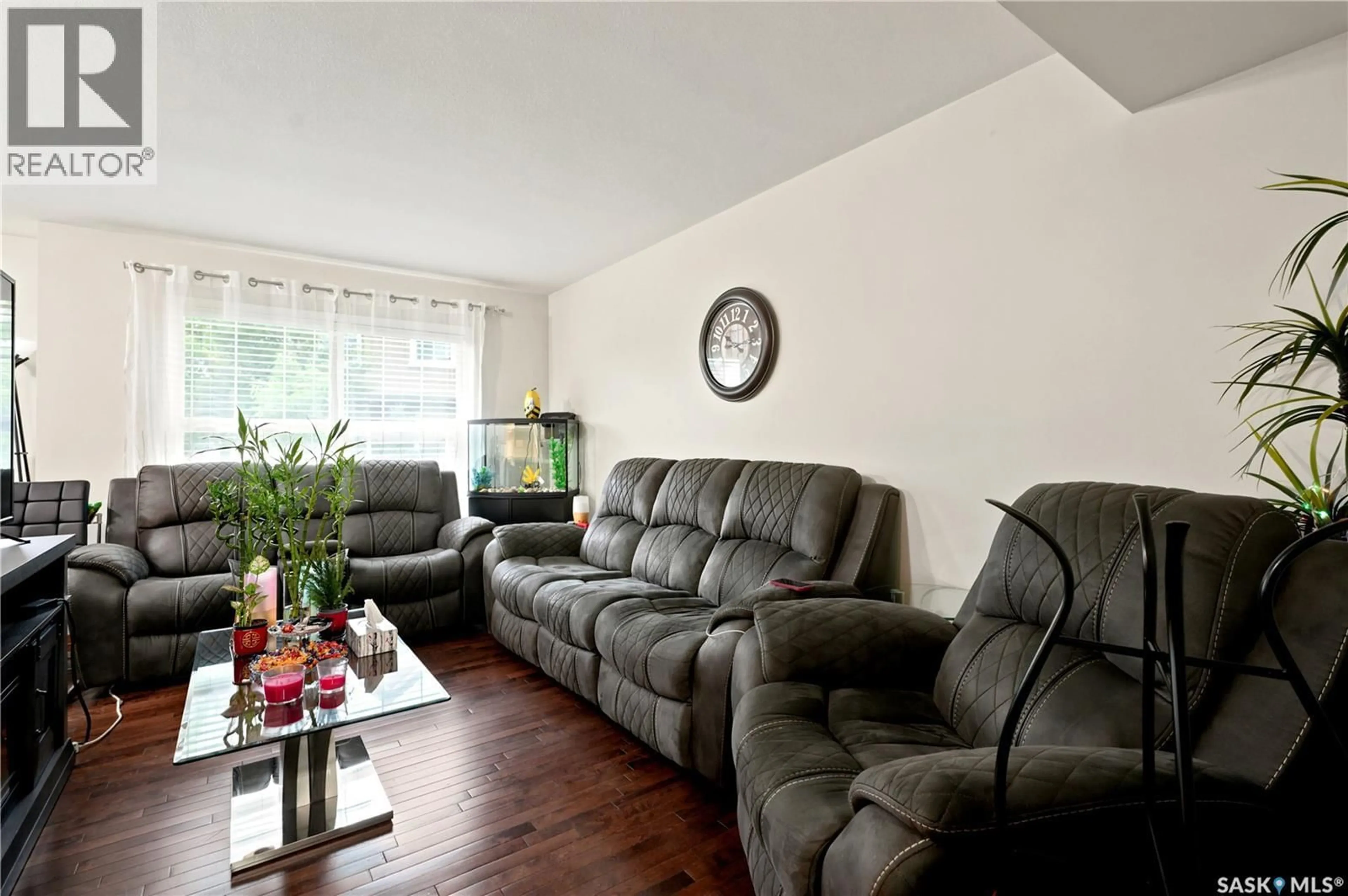 Living room with furniture, wood/laminate floor for 203 - 1555 PATON CRESCENT, Saskatoon Saskatchewan S7W0V5