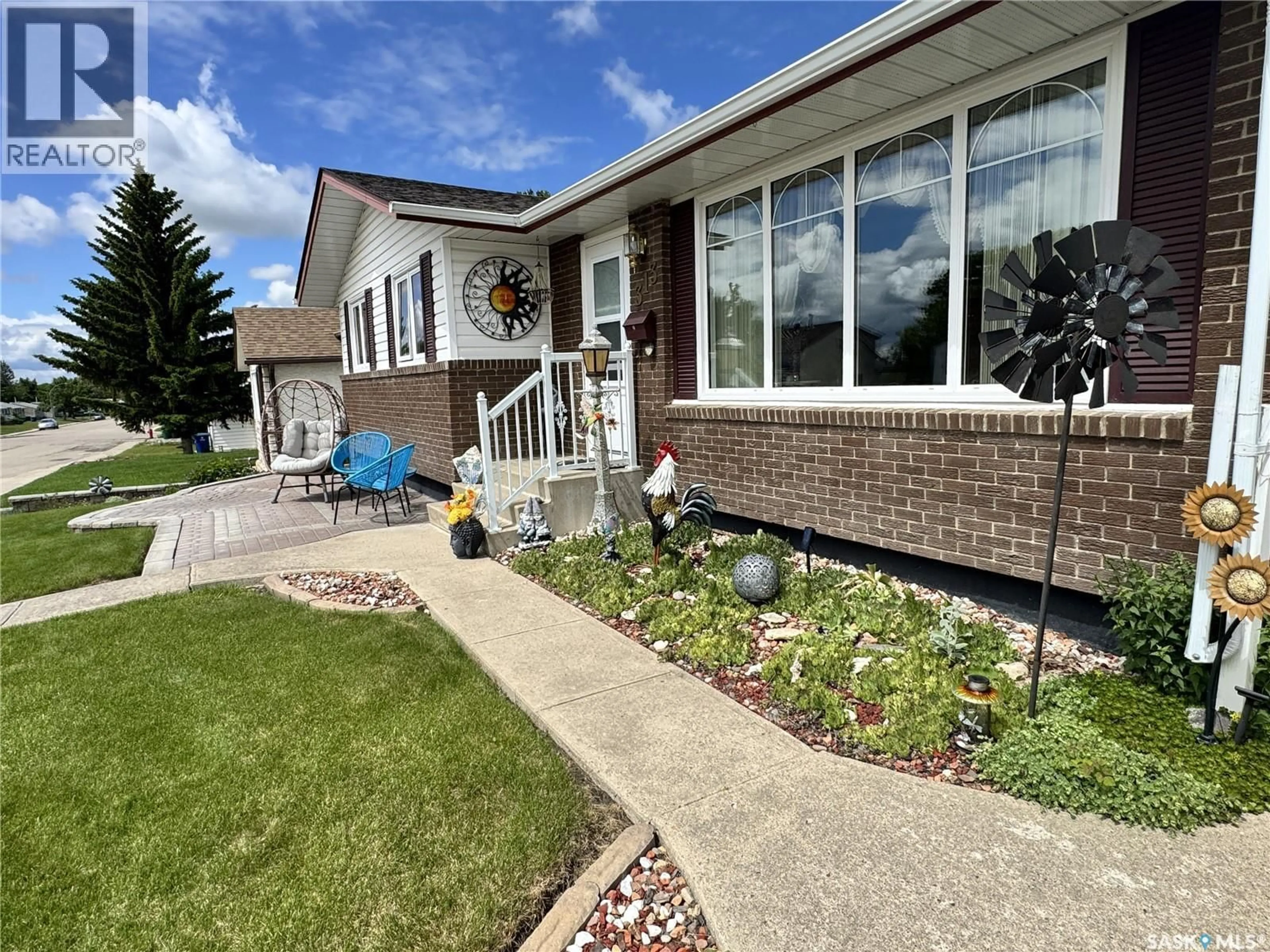 Home with vinyl exterior material, street for 313 5TH AVENUE, Biggar Saskatchewan S0K0M0