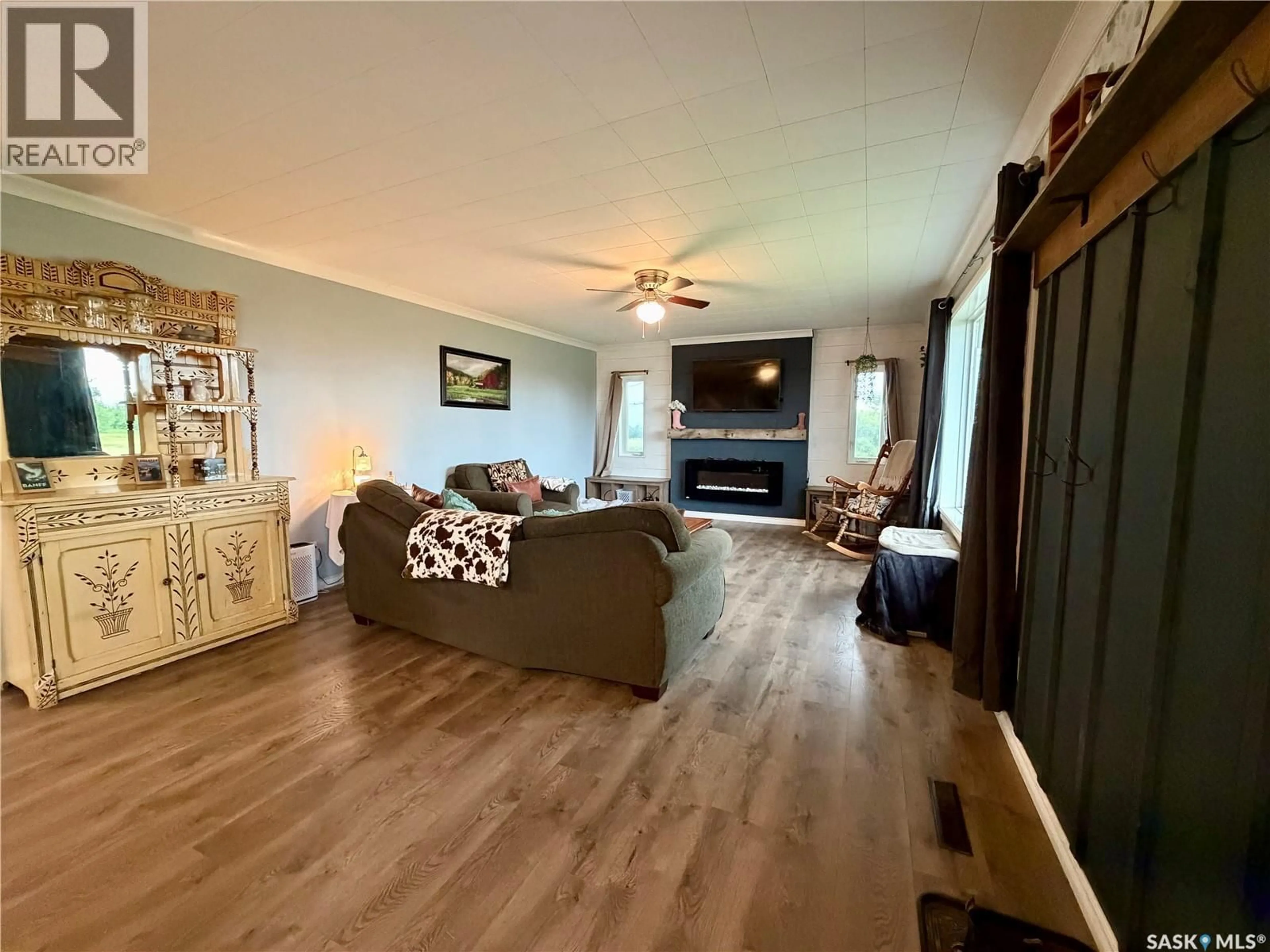 Living room with furniture, wood/laminate floor for 4 SASKATCHEWAN AVENUE, Tuxford Saskatchewan S0H4C0