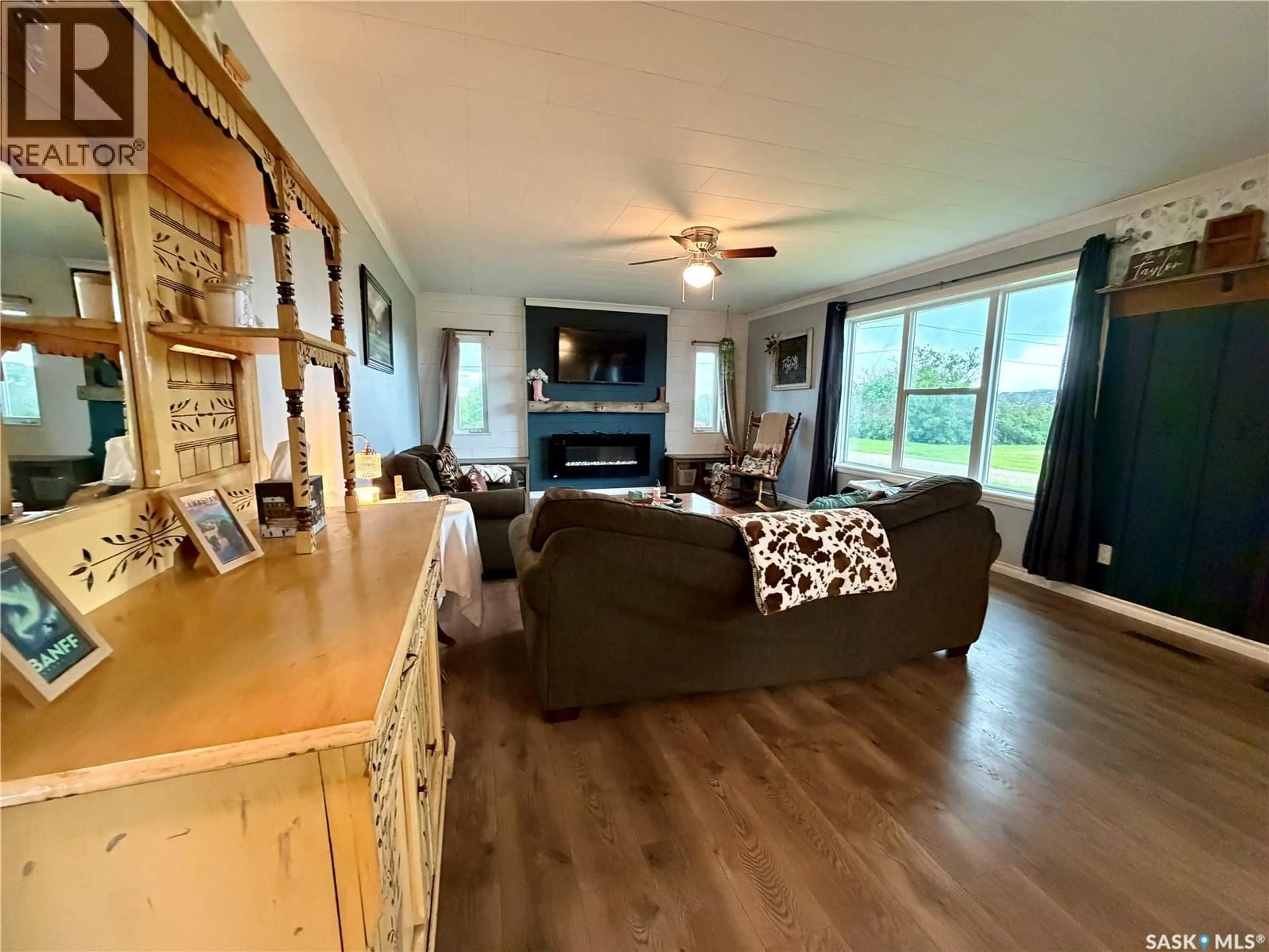 Living room with furniture, wood/laminate floor for 4 SASKATCHEWAN AVENUE, Tuxford Saskatchewan S0H4C0
