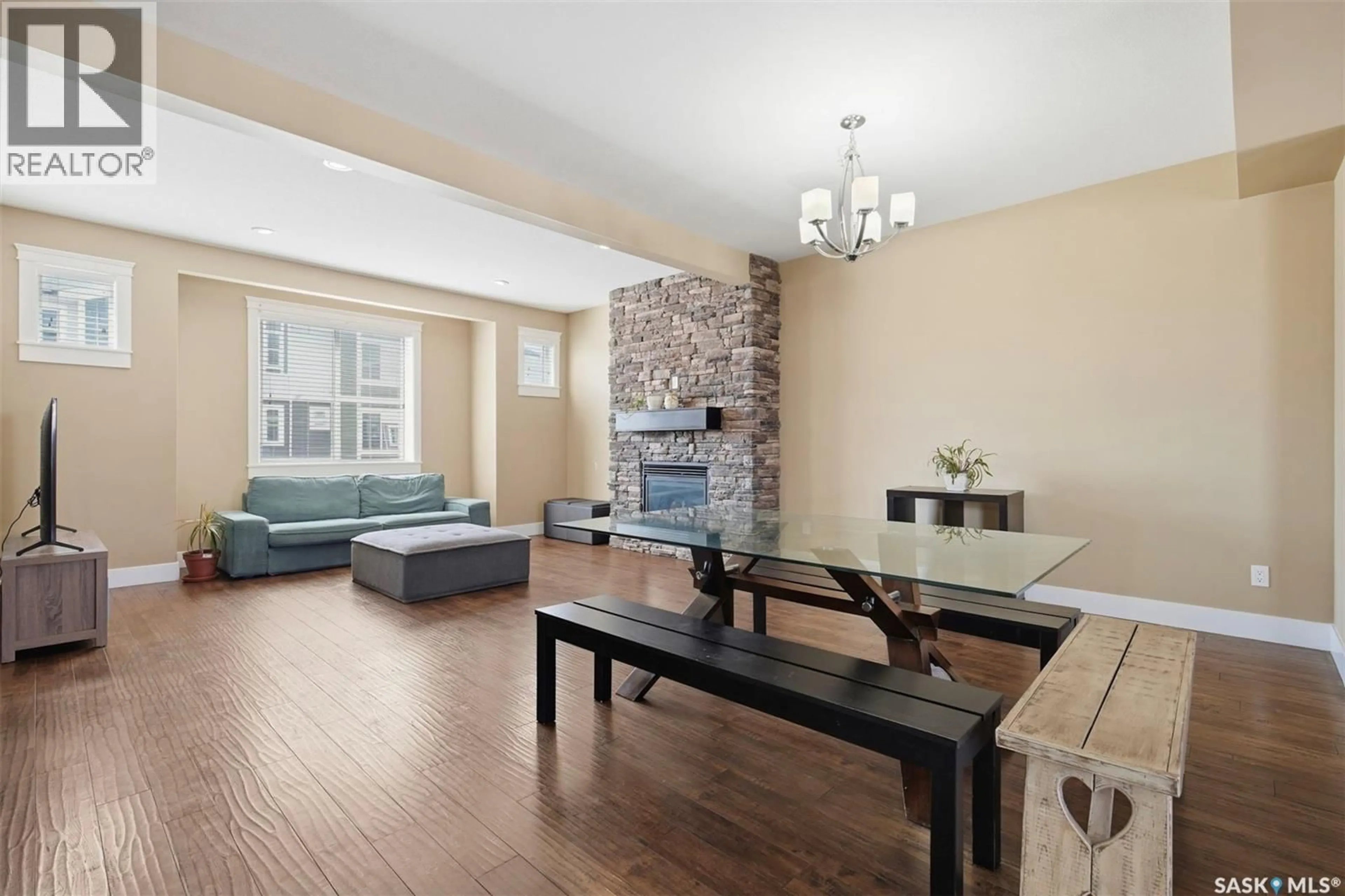 Living room with furniture, wood/laminate floor for 12 600 MAPLE CRESCENT, Warman Saskatchewan S0K4S1