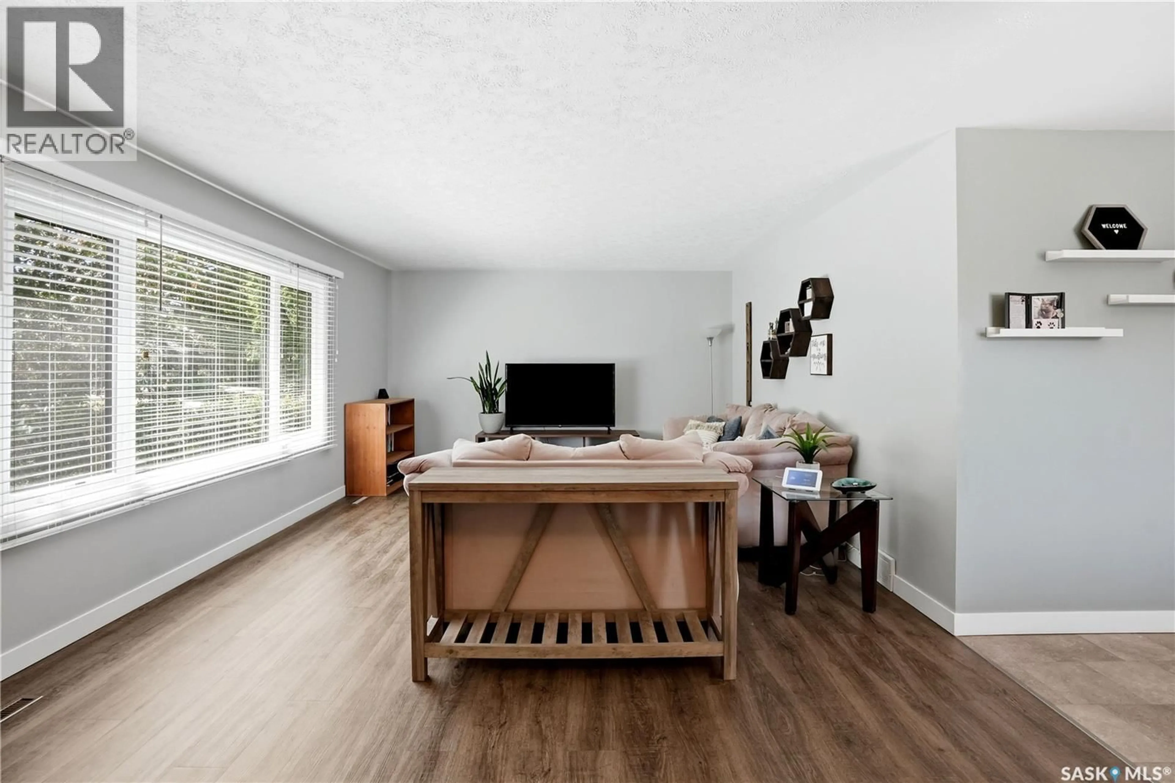 Living room with furniture, wood/laminate floor for 3216 28TH AVENUE, Regina Saskatchewan S4S2M9