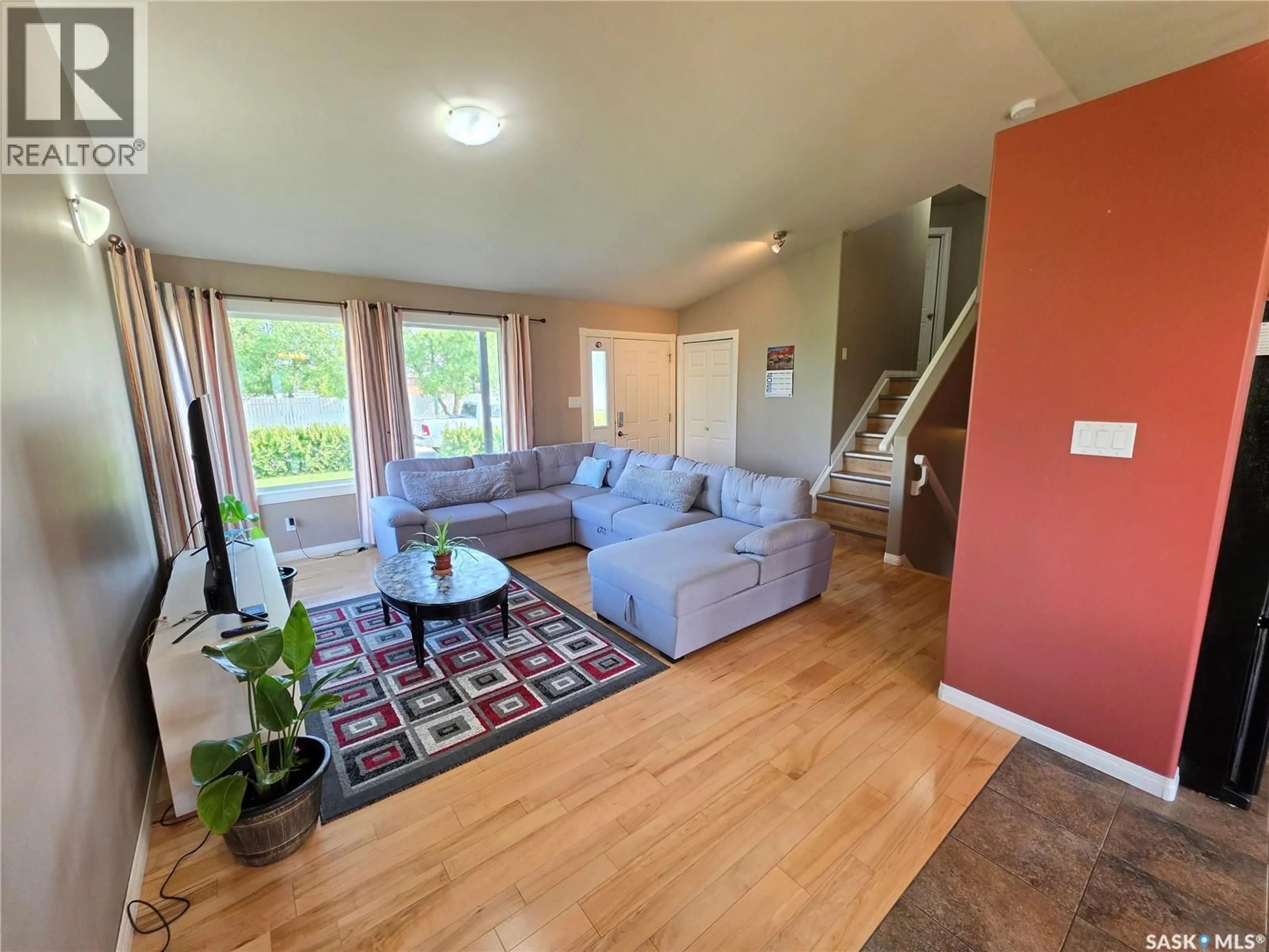 Living room with furniture, wood/laminate floor for 612 7TH AVENUE, Meadow Lake Saskatchewan S9X1B1