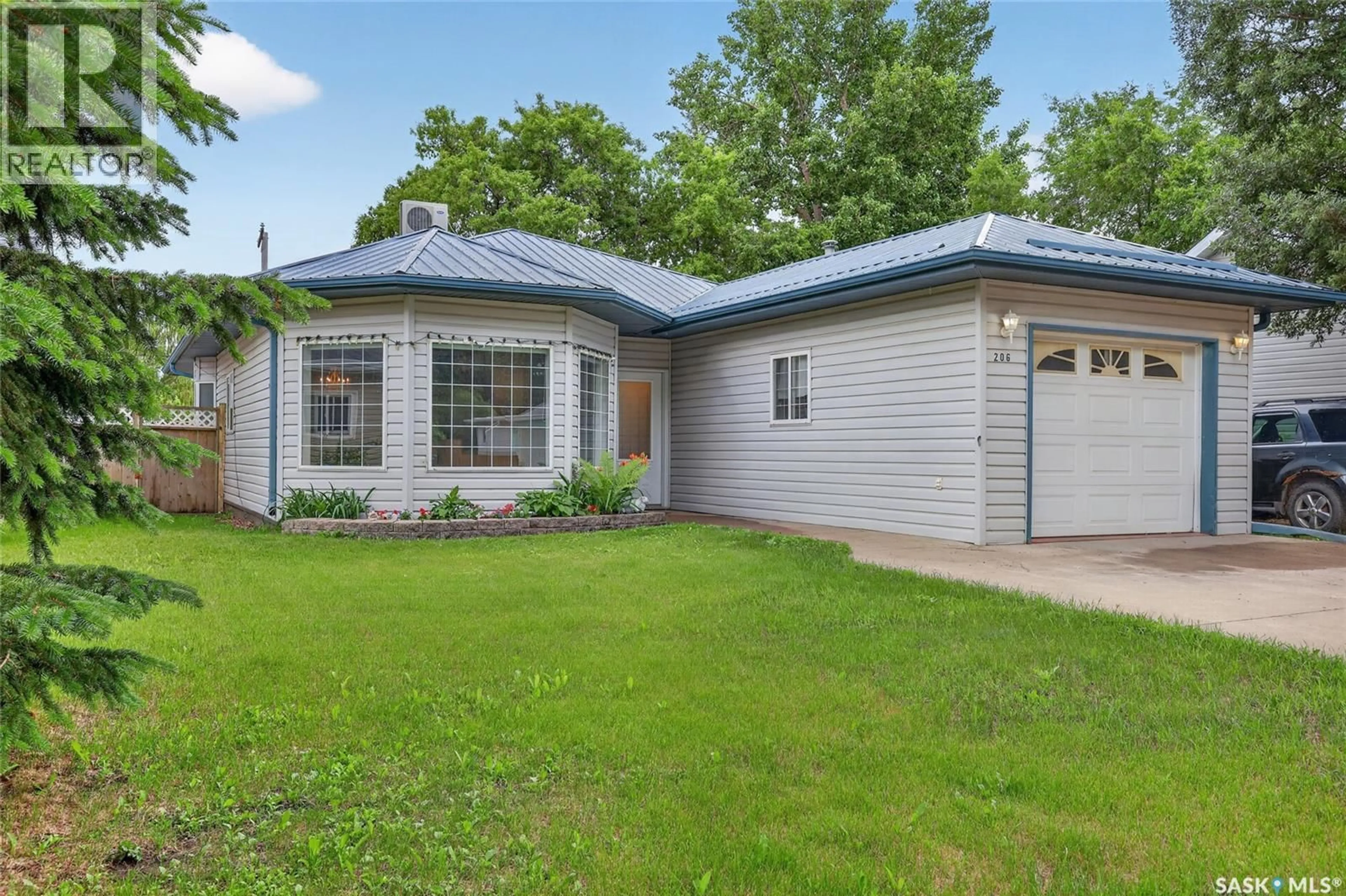 Home with vinyl exterior material, street for 206 2ND, Hague Saskatchewan S0K1X0
