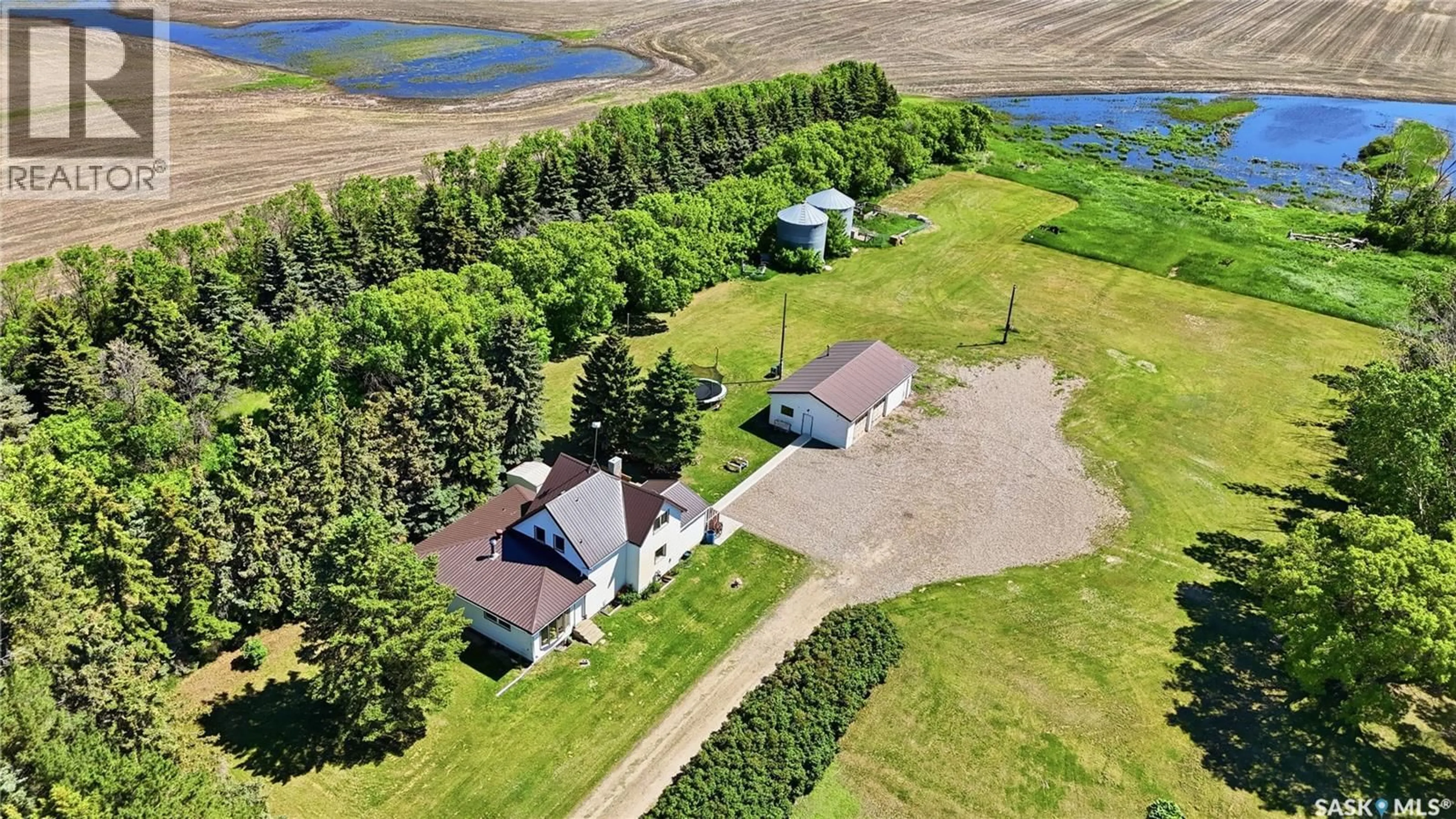 A pic from outside/outdoor area/front of a property/back of a property/a pic from drone, water/lake/river/ocean view for WATROUS WEST ACREAGE, Morris Rm No. 312 Saskatchewan S0K4Y0
