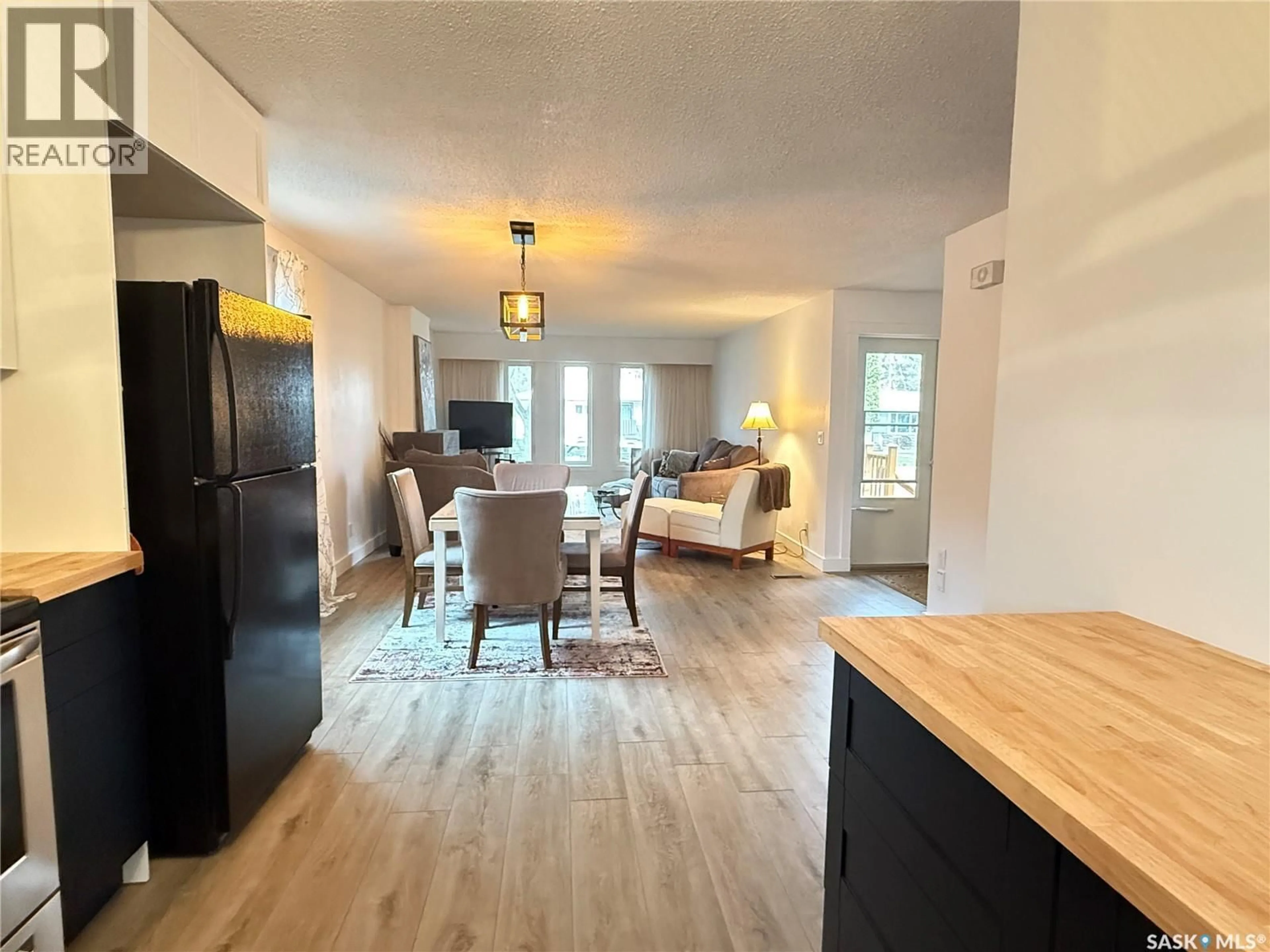 Open concept kitchen, wood/laminate floor for 615 WINDSOR STREET, Weyburn Saskatchewan S4H0X1