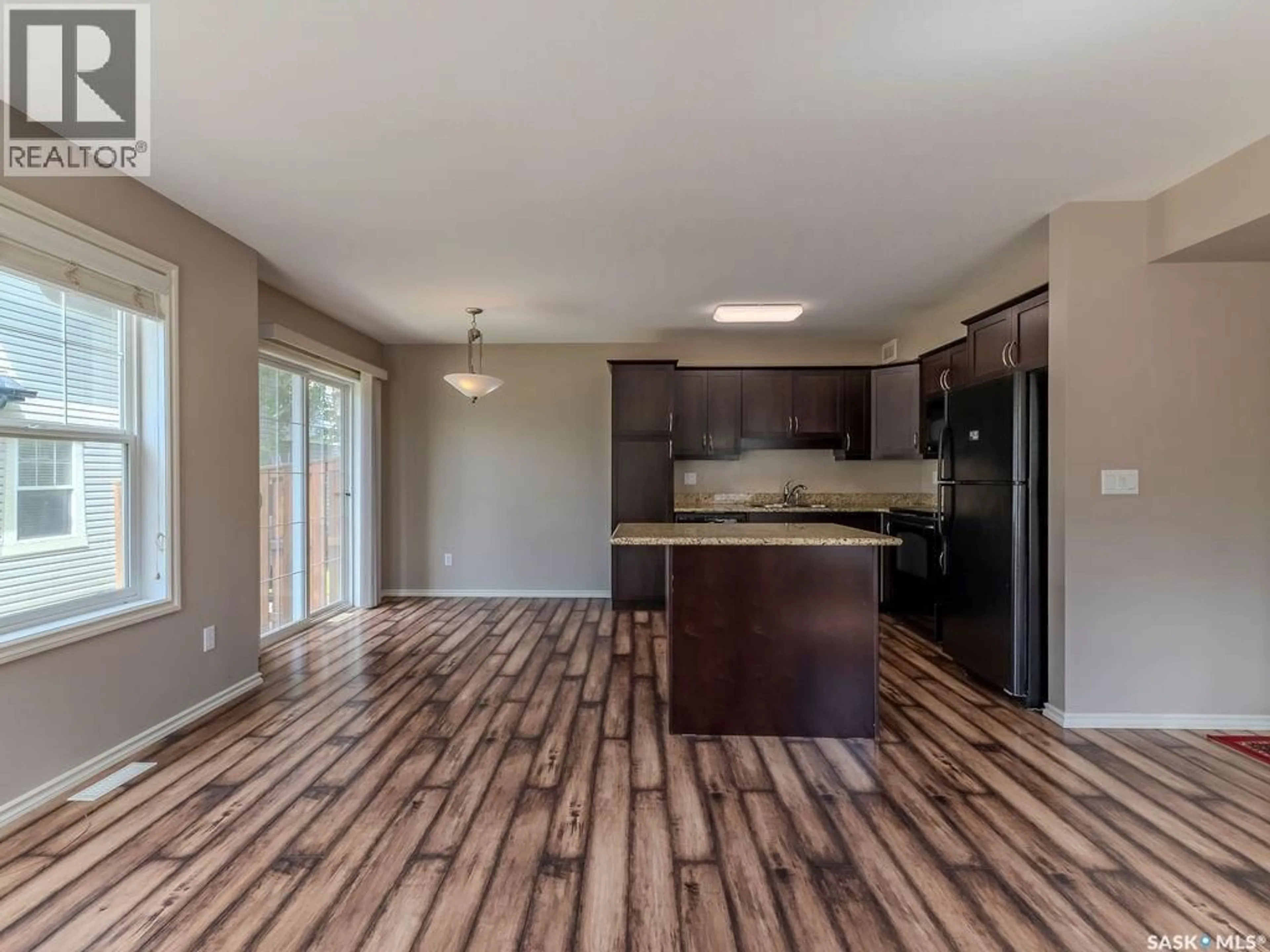 Open concept kitchen, wood/laminate floor for 615 - 214 LYND CRESCENT, Saskatoon Saskatchewan S7T0G8